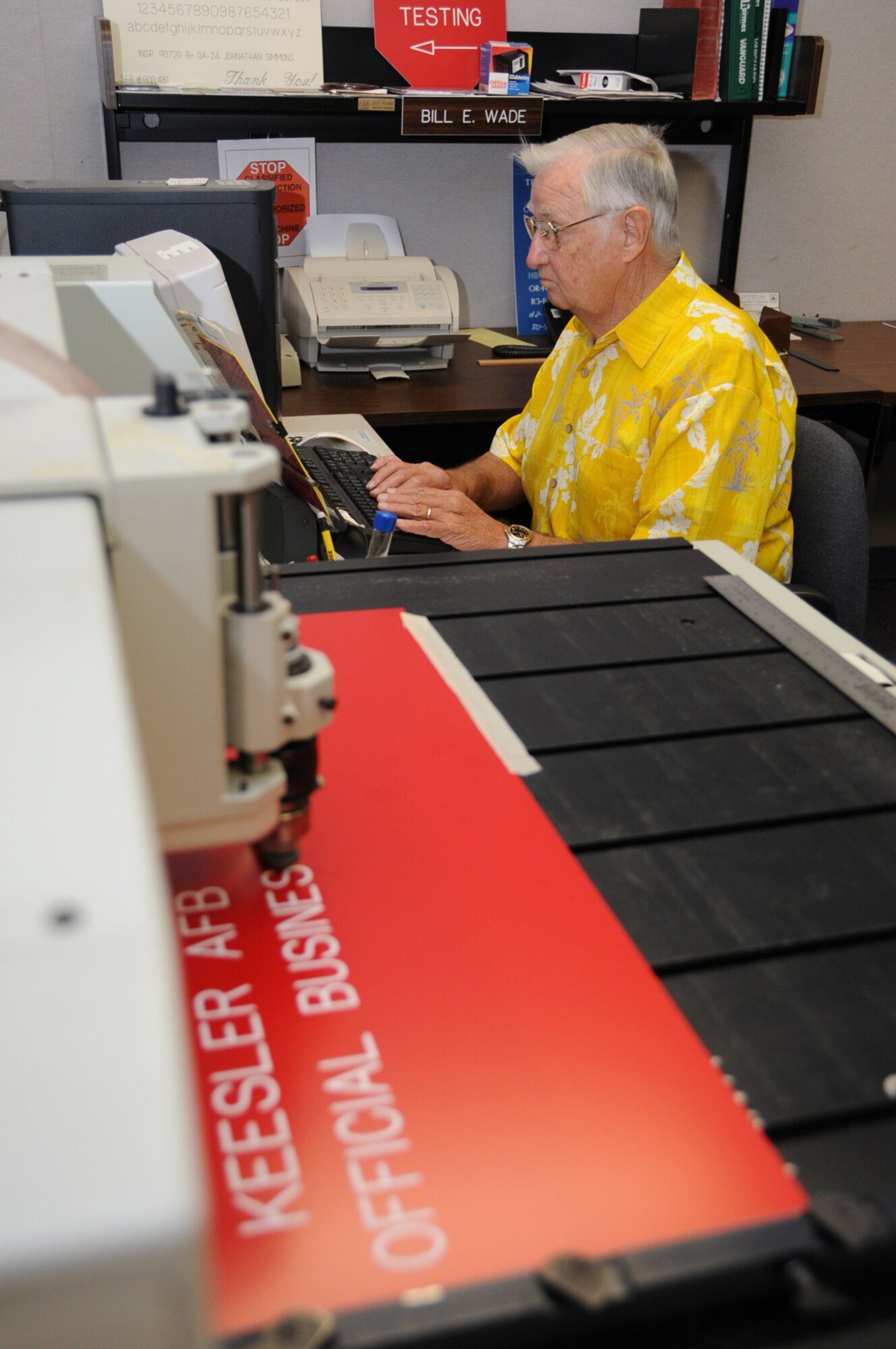 Engraver Bill Wade prepares a sign for a customer.  (U.S. Air Force photo by Kemberly Groue)