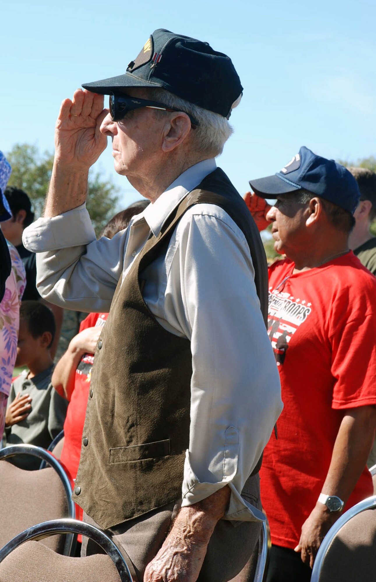 LAUGHLIN AIR FORCE BASE, Texas – A local veteran salutes the flag while the Star Spangled Banner plays during the annual Veteran’s Day ceremony in Del Rio November 11.  A four-ship formation of T-6 Texan IIs kicked off the ceremony that honored generations of American veterans. (U.S. Air Force photo by Airman 1st Class Sara Csurilla)