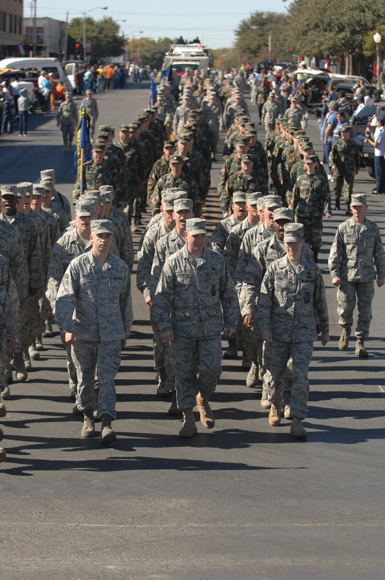 Airmen from the 312th Training Squadron lead a column of flights from Goodfellow Air Force Base as fire trucks follow during the Veterans Day Parade Nov. 8 in San Angelo. (U.S. Air Force photo by Tech. Sgt. John Barton)