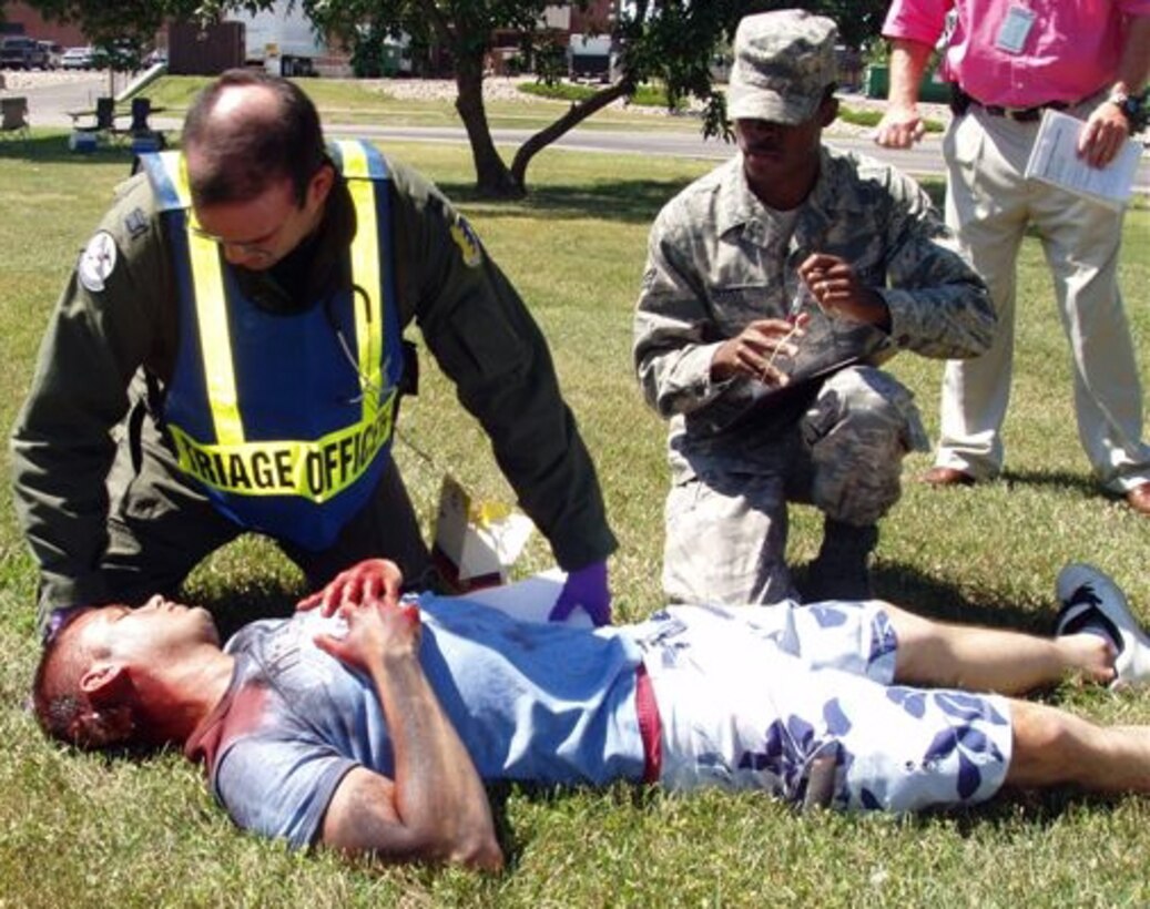 Responders exam a "victim" during an emergency exercise at Ellsworth. The "victim's" injuries were provided through the 28th Medical Group Moulage Team. The six-member team assists Ellsworth and various local community emergency response units by creating realistic simulated injury effects to treat. (Courtesy photo/28 MDG Moulage Team)
