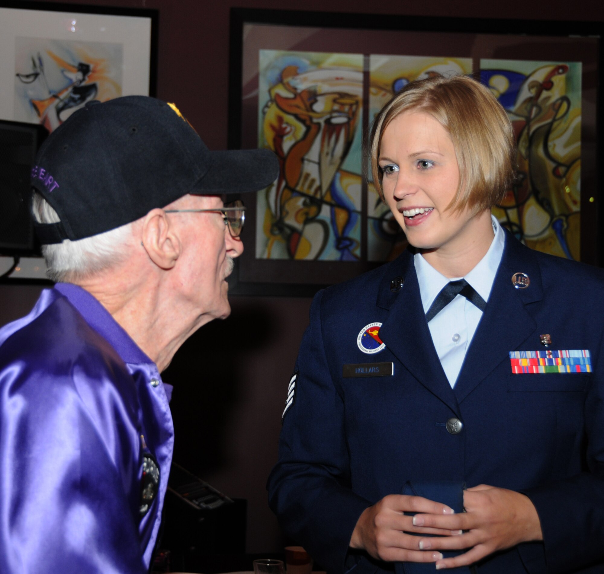 Retired Command Sgt. Maj. A.A. Pilutti of Ocean Springs who served with Army Special Forces chats with Staff Sgt. Crystal Hollars, an Airman Leadership School instructor, at a reception at the Hard Rock Casino Hotel before the parade.  (U.S. Air Force photo by Kemberly Groue)