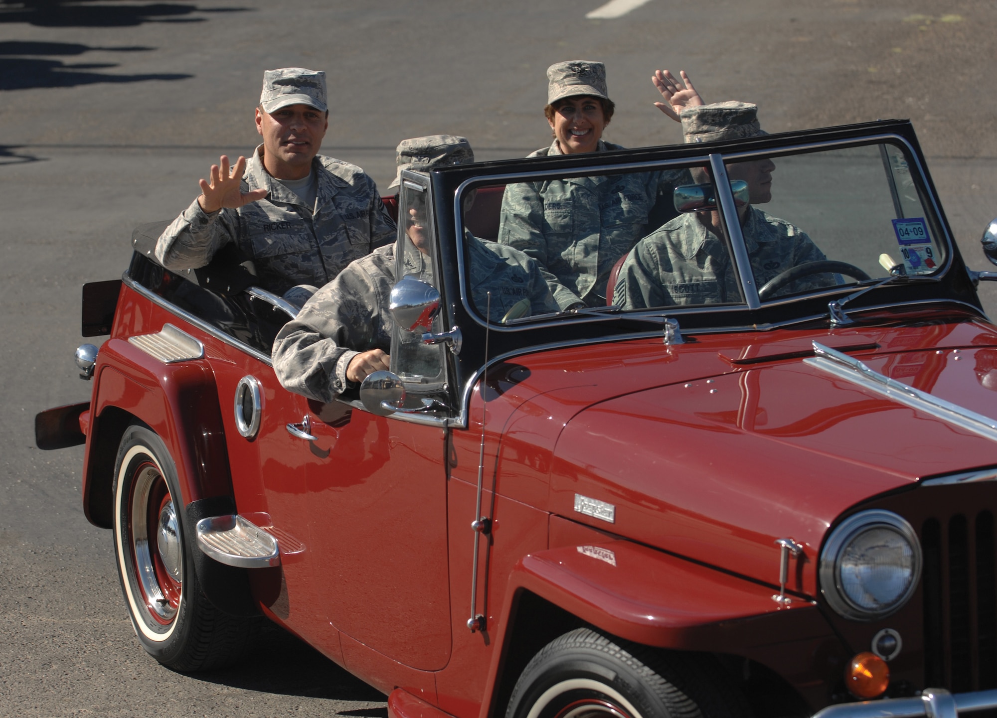 Colonel Merrily Madero (right), 17th Training Wing vice commander, Col. Anthony Lombardo (center), 17th Training Group commander, and Chief Master Sgt. Frederick Ricker, 17 TRW command chief master sergeant, wave to parade participants and spectators as they ride in the Veterans Day Parade Nov. 8 in San Angelo. (U.S. Air Force photo by Tech. Sgt. John Barton)