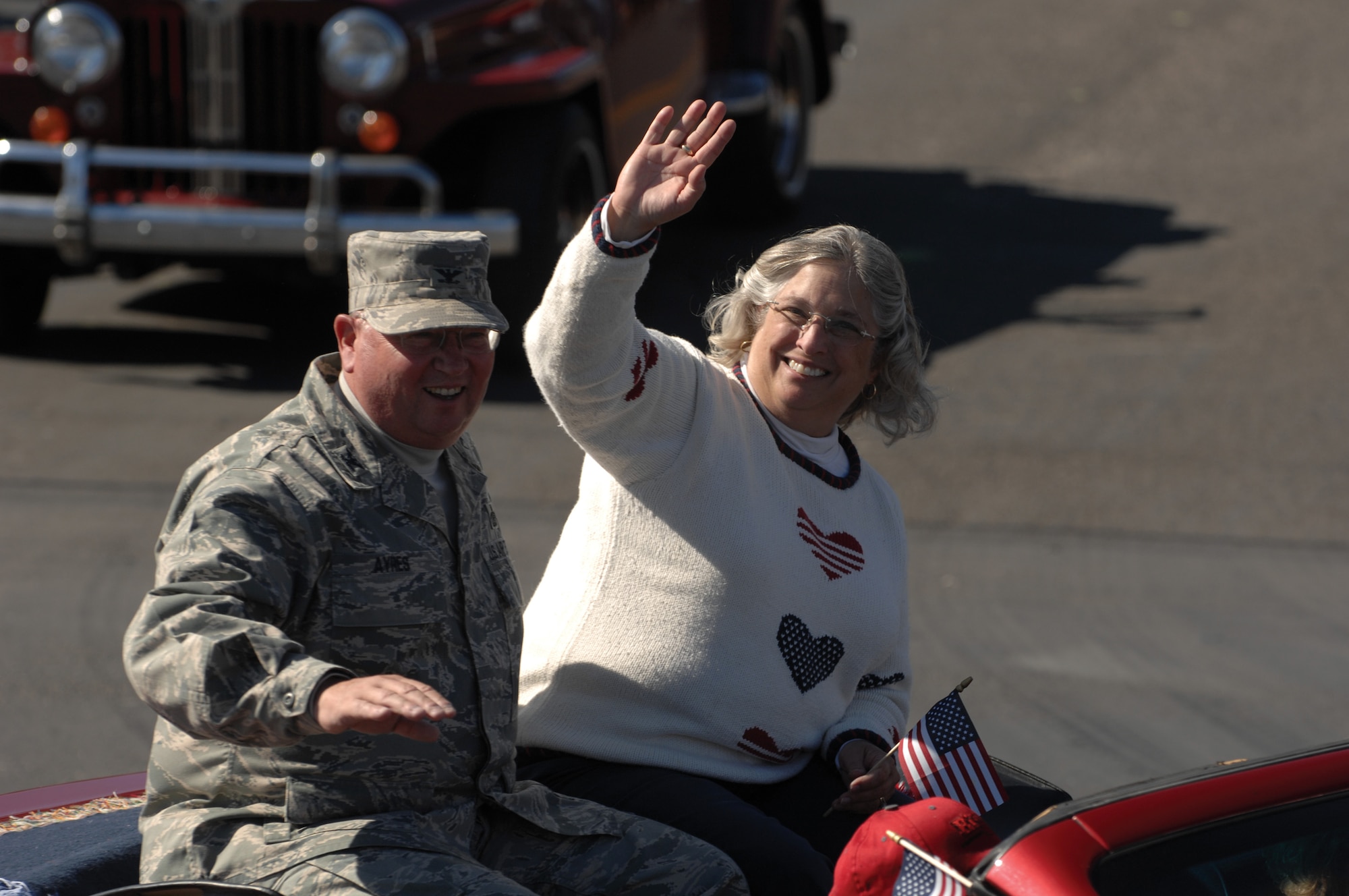Colonel Richard Ayres, 17th Training Wing commander, and his wife, Betsy, wave to parade participants and spectators as they ride in the Veterans Day Parade Nov. 8 in San Angelo. (U.S. Air Force photo by Tech. Sgt. John Barton)