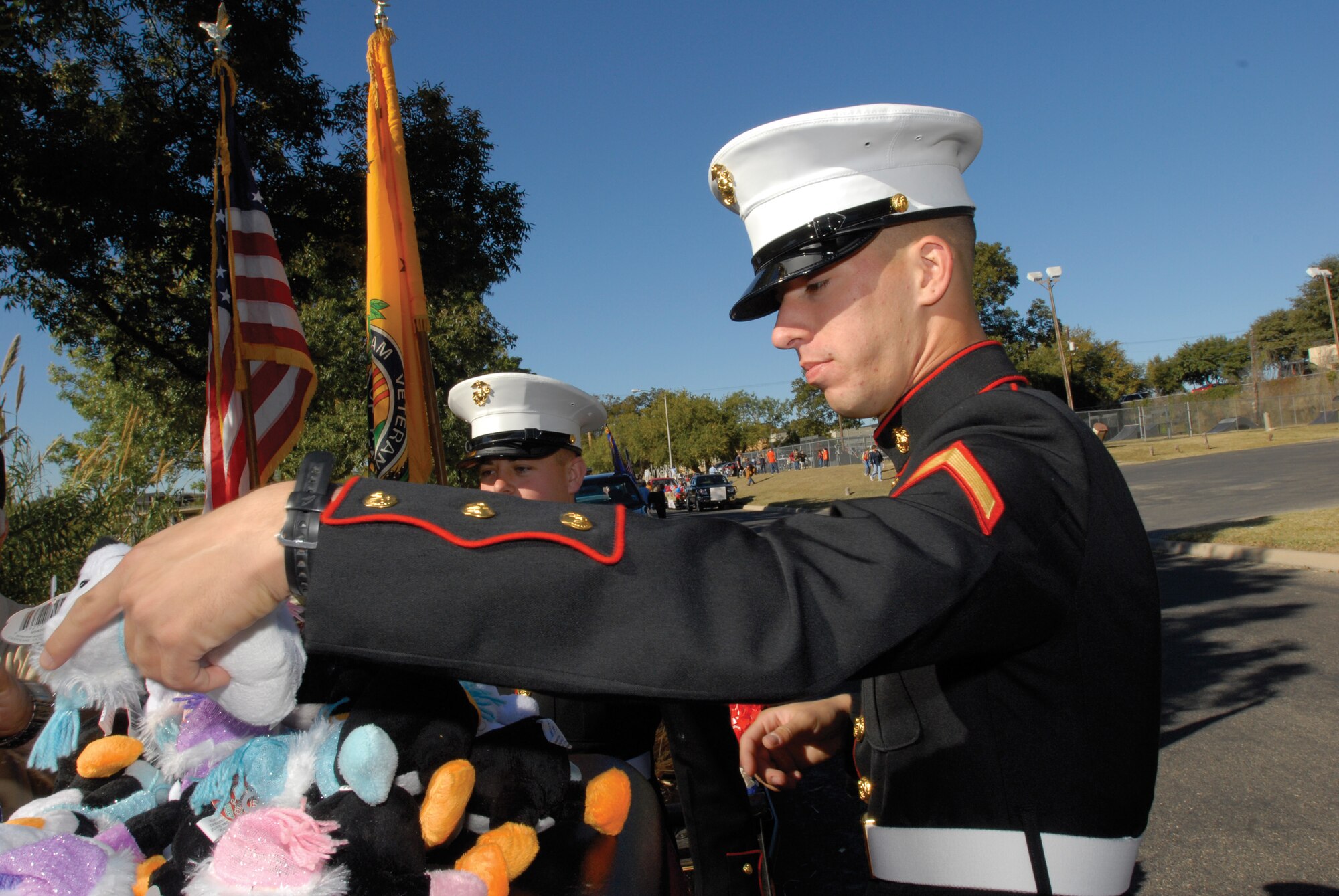 Marine Pfc. Mark Adam collects toys for the Toys for Tots campaign during the Veterans Day Memorial at San Angelo Regional Airport Mathis Field Nov. 8. (U.S. Air Force photo by Master Sgt. Randy Mallard)