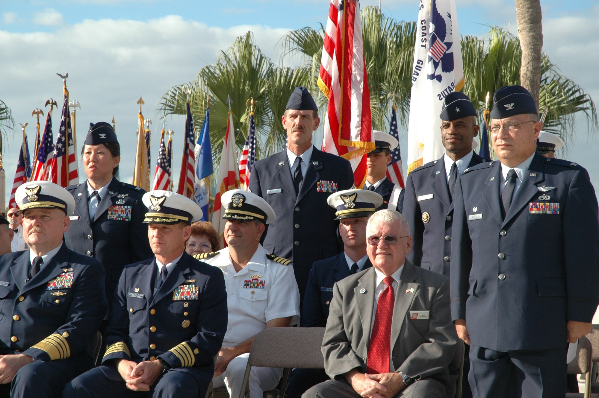 As soon as the notes from the Air Force Song were played, all current and former Airmen were asked to stand during the 26th Annual “Massing of the Colors” held Tuesday at Brevard Community College in Cocoa. Standing to honor our nation’s veterans are (left to right) Col. Lisa Ann Onaga, commander, Air Force Technical Applications Center, Chief Master Sgt. John Nederhoed, AFTAC superintendent, Brig. Gen. Edward L. Bolton, Jr., commander, 45th Space Wing and Col. George Pierce, commander, 920th Maintenance Group. Seated at the lower left is Adm. Thad Allen, commandant, U.S. Coast Guard, who served as the guest speaker. (U.S. Air Force photo by Chris Calkins)