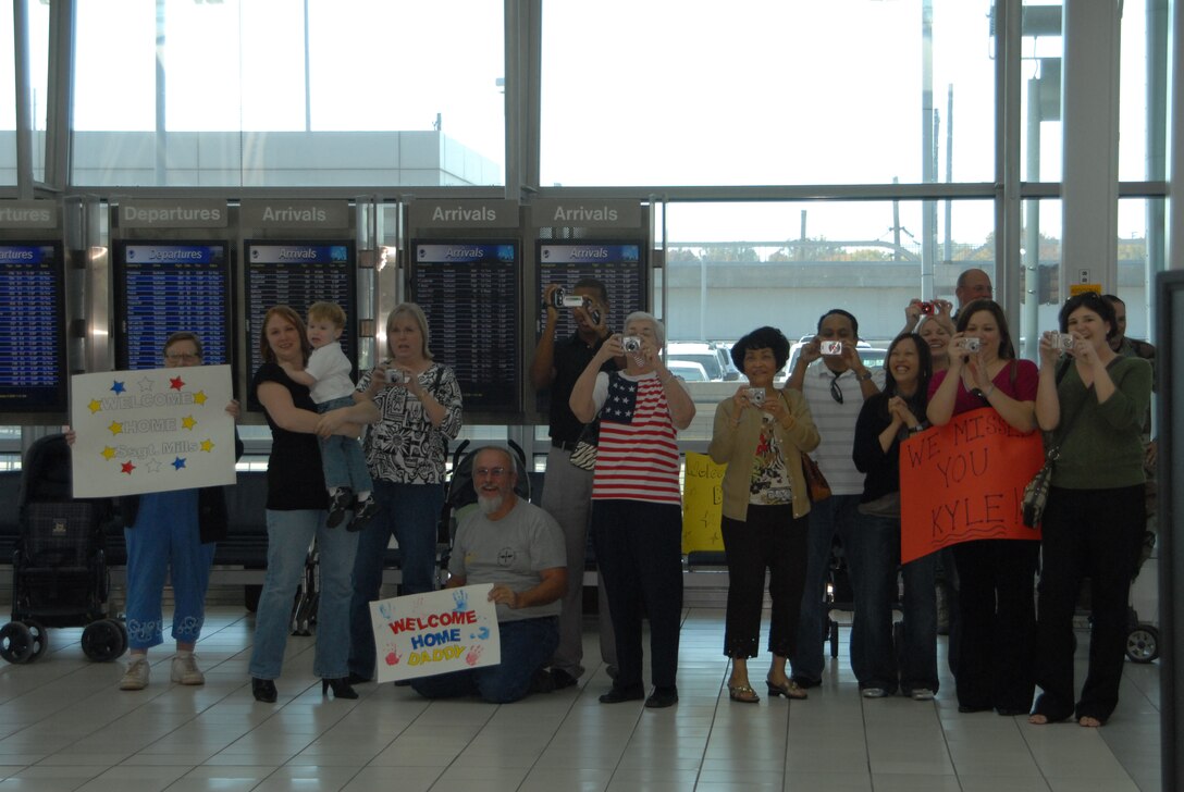 ST. LOUIS - Famly members gather to await the return of 126th Civil Engineering Squadron personnel at Lambert International Airport, St Louis, Mo.  The Illinois Air National Guard members assigned to the 126th Air Refueling Wing recently returned from a four month overseas deployment.  (U.S. Air Force photo by Capt. Jennifer Howsare) (released)