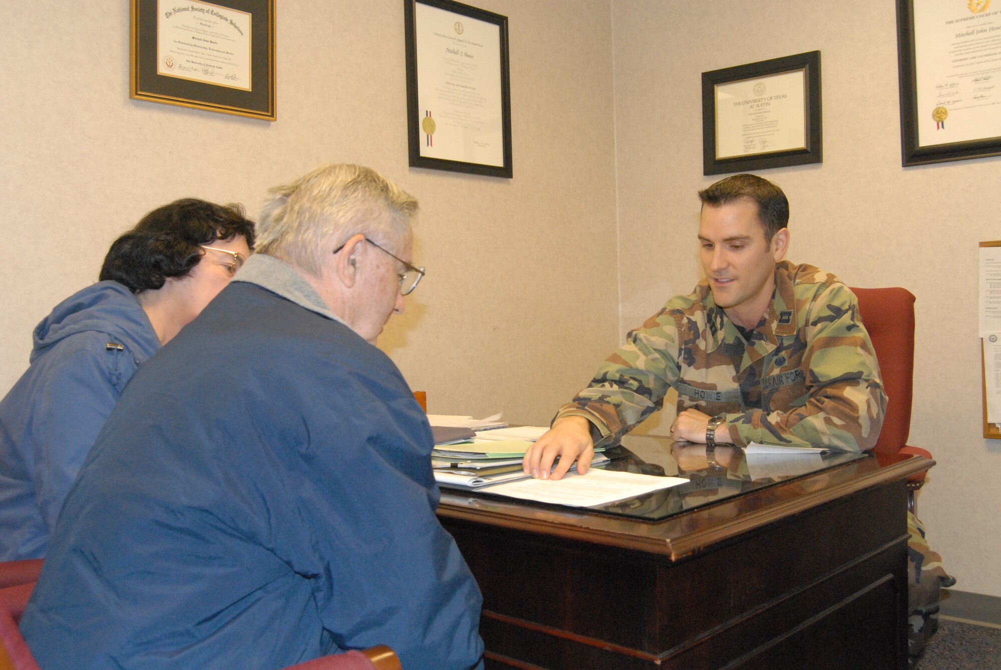 Retired Senior Master Sgt. Alfred Johnson and his wife Elizabeth go over their will preparation with Capt. Mitchell Howie, 43rd Airlift Wing Assistance Judge Advocate Wednesday at the Wing Headquarters building. Captain Howie is one of the many staff available with the 43rd AW Judge Advocate that can assist active duty, dependents and retirees. The office is open Monday through Friday from 10 a.m. to 3:30 p.m. to provide legal assistance. (U.S. Air Force Photo by Tech. Sgt. Todd Wivell)