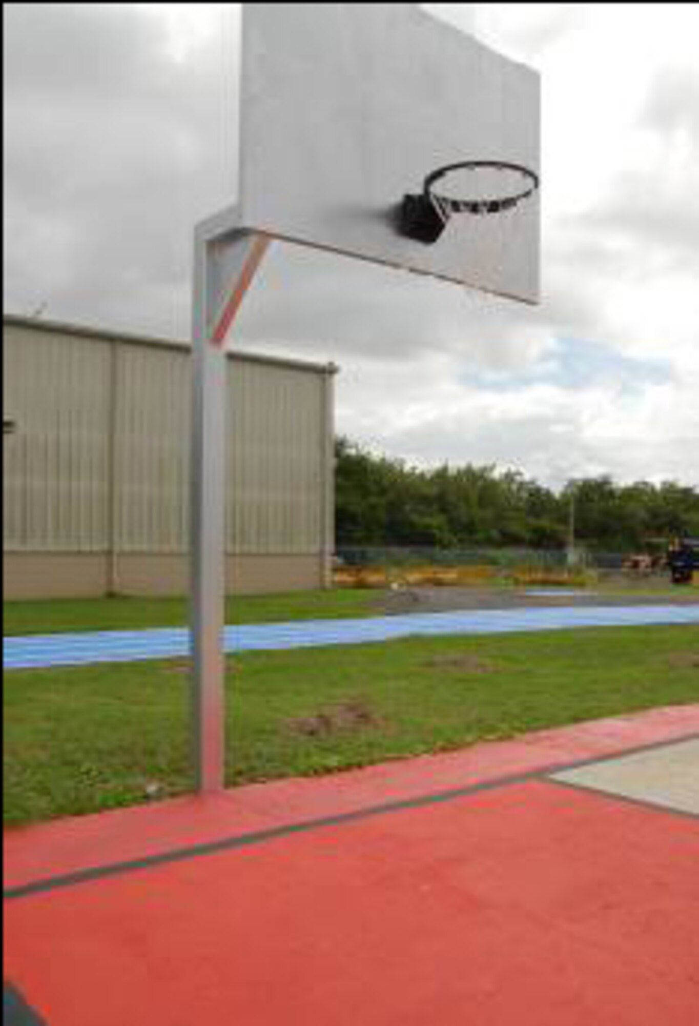 Volunteers repainted the Muniz basketball court. The backboard and basketball rim were given corrosion control treatment and repainted as well. 