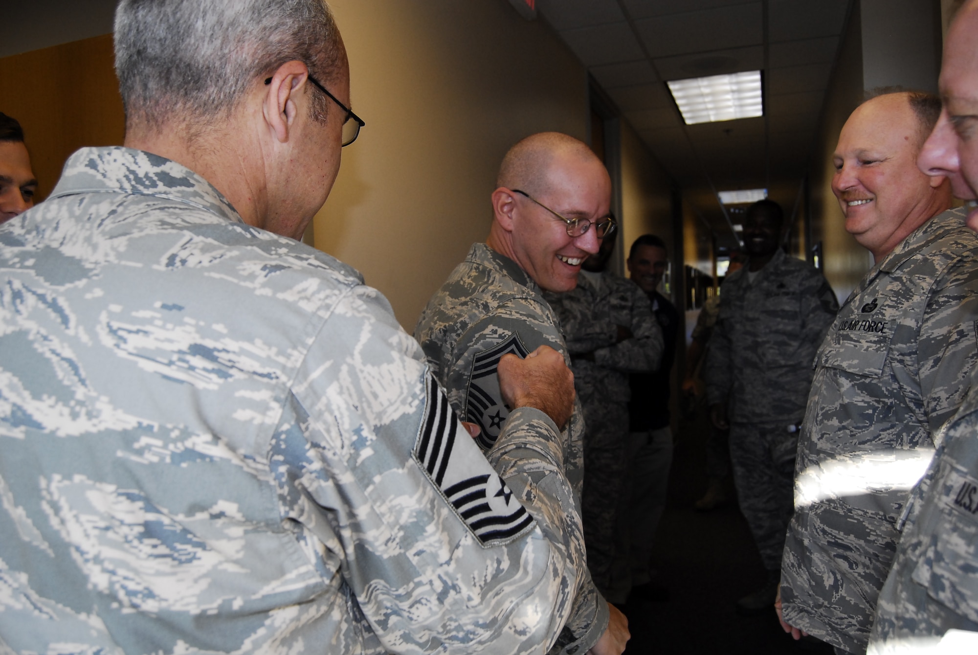 Senior Master Sgt. Adam Marks, 43rd Aeromedical Evacuation Squadron, gets his stripes pinned on by Pope’s chief master sergeants Nov. 11.  He was one of six Pope Airmen selected to the rank of Chief Master Sgt. Others selected were Senior Master Sgt. Dean Thompson, 24th Special Tactics Squadron; Senior Master Sgt. Peter Klein, 18th Air Support Operations Group, Senior Master Sgt. Douglas Frye, 11th Intelligence Squadron, Senior Master Sgt. Jennifer Bloomer and Senior Master Sgt, Scott Doremus, data masked. (U.S. Air Force Photo by Airman 1st Class Mindy Bloem)