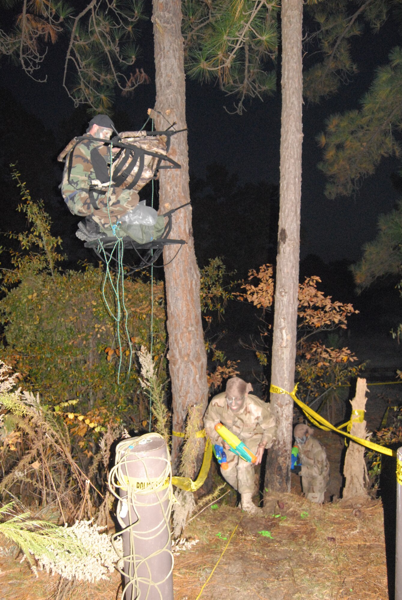 Members of the 43rd Communications Squadron navigate the obstacle course during their Combat Dining In Nov. 7 in the wooded area behind the railroad tracks on Hurst Drive. Before being able to eat, participating members had to traverse through the obstacle course, low crawl to the end and then slide into a mud pit. (U.S. Air Force Photo by 2nd Lt. Chris Hoyler)