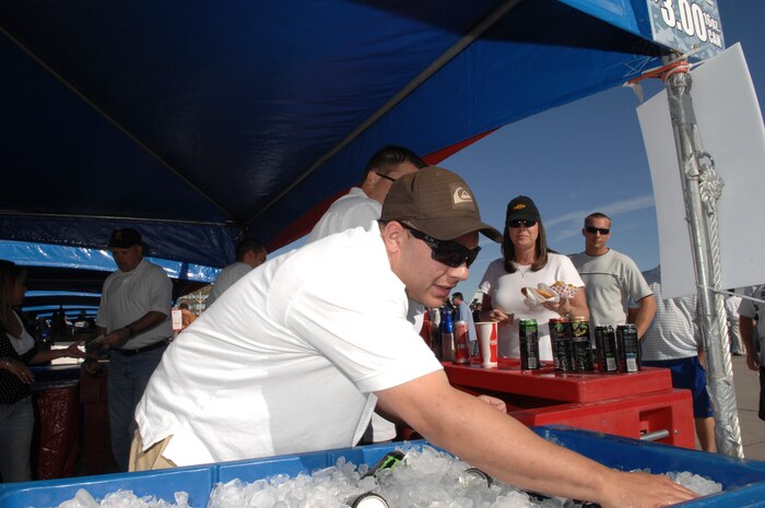 Technical Sgt. Moise Marte, a advance weapons director student assigned to the 8th Weapons Squadron, grabs drinks for customers during Aviation Nation at Nellis Air Force Base, Nev., Nov. 8, 2008.The Nellis AFB air show showcased the 21st-century Air Force’s capabilities in air, space and cyberspace. The show, held Nov. 8-9. is the largest aviation event in Las Vegas and the largest free public event in Nevada.
(U.S. Air Force Photo/Senior Airman Larry E. Reid Jr.)