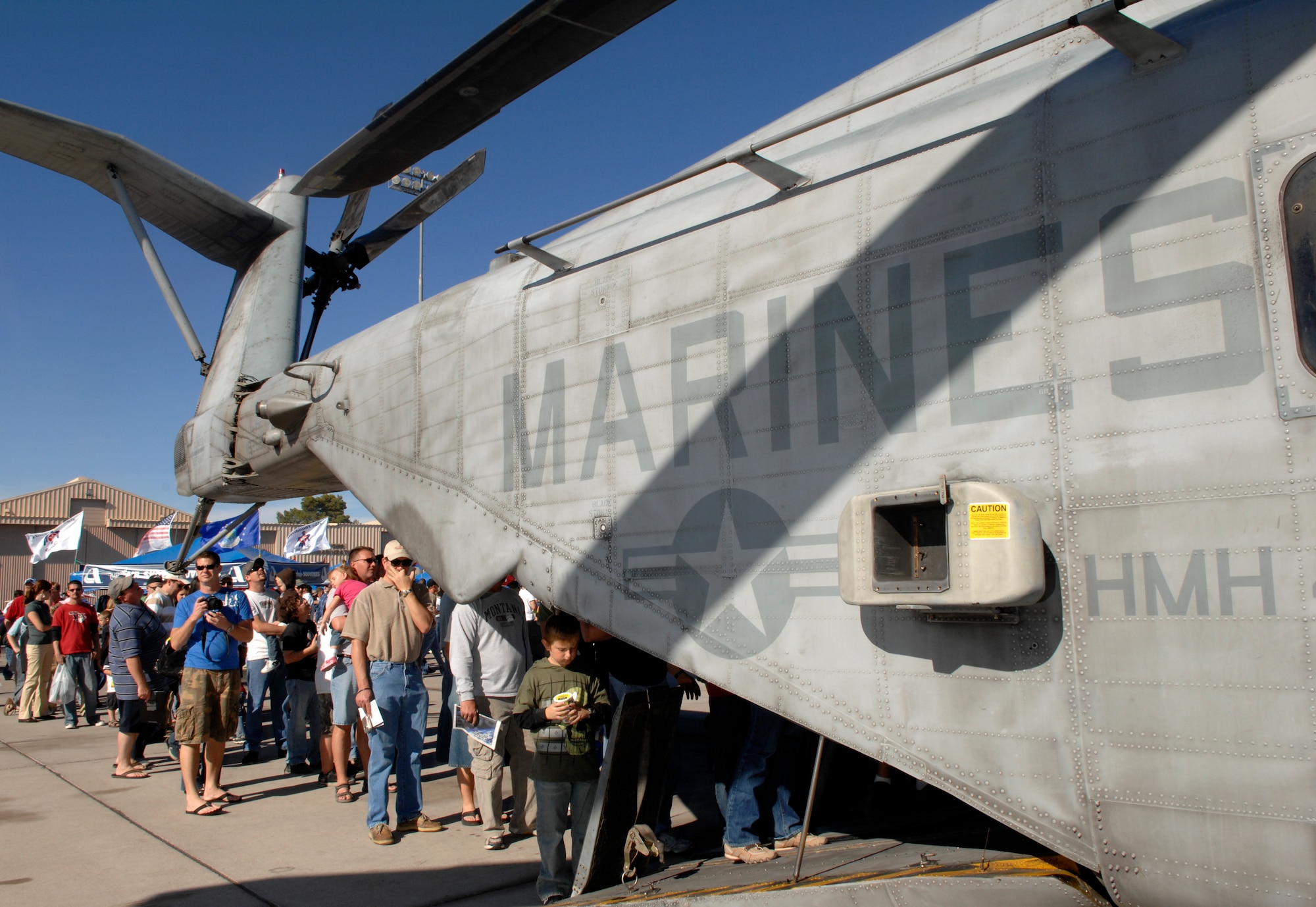 Air show spectators file inside of a U.S. Marine Corps CH-53E Super Stallion static display during an air show at Nellis Air Force Base, Nev., Nov. 8, 2008.  The Nellis AFB air show showcased the 21st-century Air Force’s capabilities in air, space and cyberspace. The show, held Nov. 8-9. is the largest aviation event in Las Vegas and the largest free public event in Nevada.
(U.S. Air Force Photo/Senior Airman Larry E. Reid Jr.)