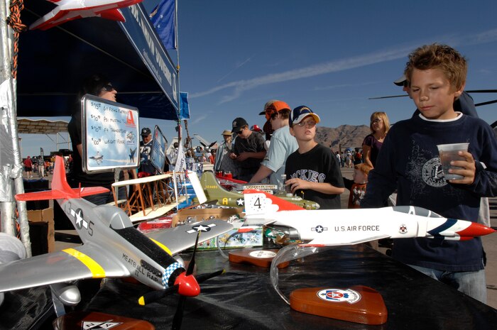 An air show guest browses a souvenir booth during an air show at Nellis Air Force Base, Nev., Nov. 8, 2008.  The Nellis AFB air show showcased the 21st-century Air Force’s capabilities in air, space and cyberspace. The show, held Nov. 8-9. is the largest aviation event in Las Vegas and the largest free public event in Nevada.
(U.S. Air Force Photo/Senior Airman Larry E. Reid Jr.)