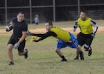 Charles Lombardia, fire department intramural football team running back, tries to get by Willie Castor, 12th Mission Support Squadron intramural football team member, during the season opening game Nov. 12 at Grater Field. The 12th MSS team toppled the firemen 14-6. (U.S. Air Force photo by Melissa Peterson)