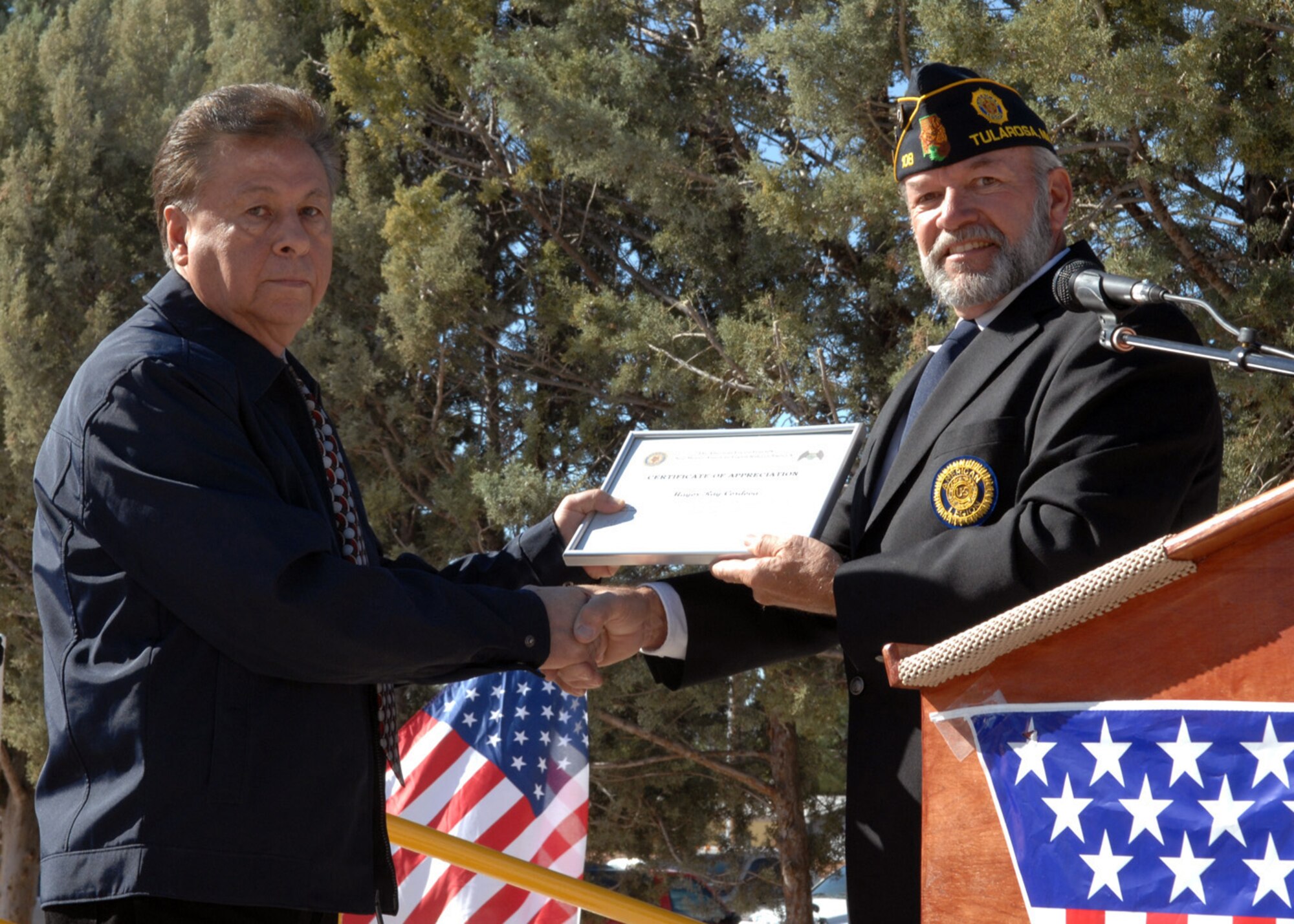 Ed Summerall, American Legion Post 108 commander, presents Mayor Ray Cordova, with a certificate of appreciation during the Veterans Day Observance ceremony in Tularosa, N.M., Nov. 11. As a guest speaker, Mayor Cordova showed his appreciation with a speech for all veterans that gathered together at the Tularosa Veterans Memorial Park. (U.S. Air Force photo/Airman 1st Class Veronica Salgado)
