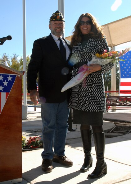 Kathy Harrigian, wife of Col. Jeff Harrigian, 49th Fighter Wing commander at Holloman Air Force Base, N.M., is presented with flowers for her support during the Veterans Day Observance, Nov. 11. Ed Summerall, American Legion Post 108 command thanks all members of the military at the Tularosa Veterans Memorial Park, N.M. (U.S. Air Force photo/Airman 1st Class Veronica Salgado)