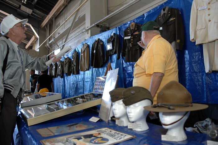 Mr. William Schott (right), shows off historical military uniforms to a customer at the aviation history and exhibits hangar during an air show at Nellis Air Force Base, Nev., Nov. 8, 2008. The Nellis AFB air show showcased the 21st-century Air Force’s capabilities in air, space and cyberspace. The show, held Nov. 8-9. is the largest aviation event in Las Vegas and the largest free public event in Nevada.
(U.S. Air Force Photo/Senior Airman Larry E. Reid Jr.)