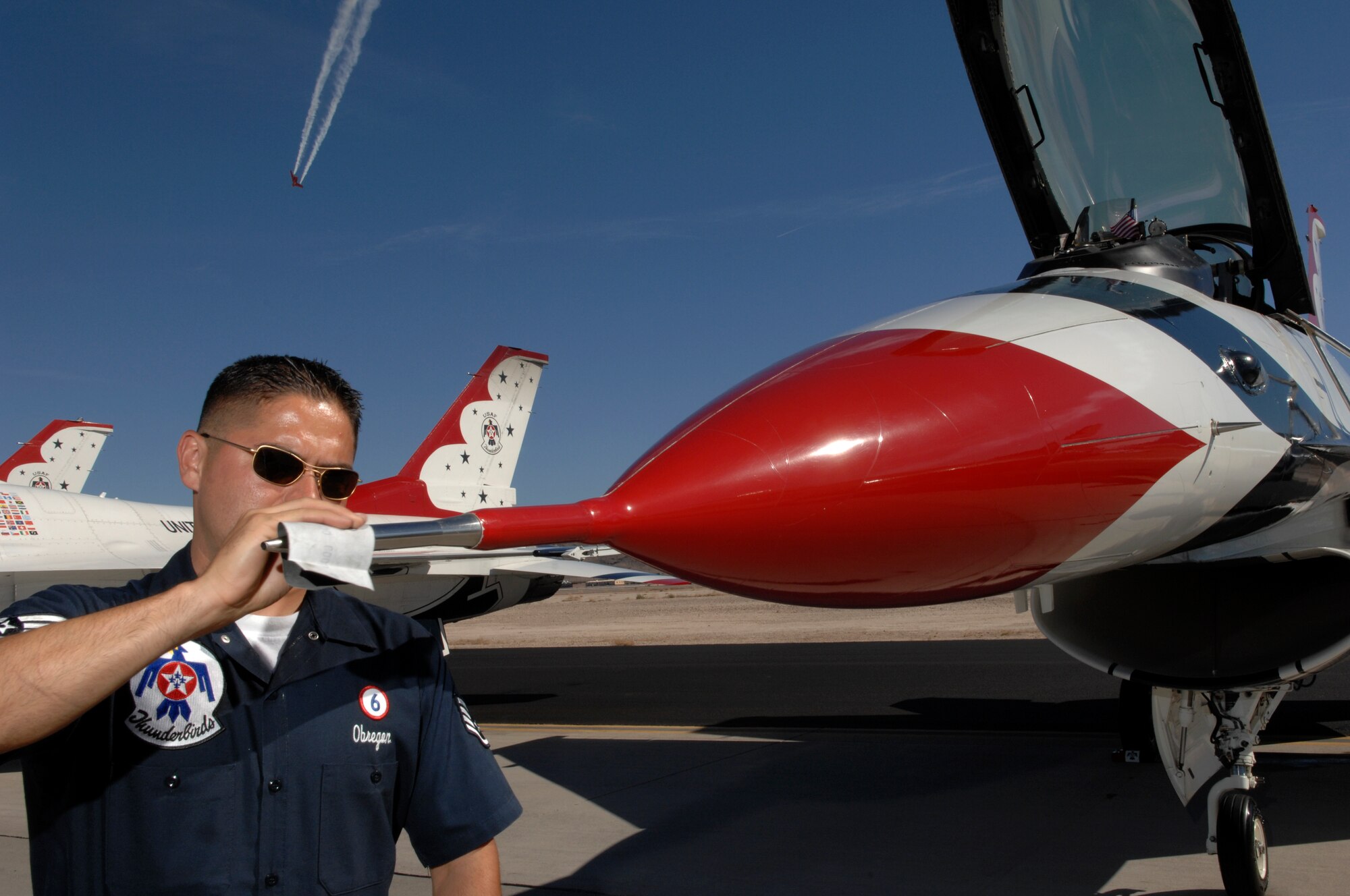 Staff Sgt. Carlos Obregon, U.S. Air Force Air Demonstration Squadron, the Thunderbirds, assistant crew chief for the Thunderbird six jet, polishes the crome prior to the Thunderbirds performance during an air show at Nellis Air Force Base, Nev., Nov. 8, 2008. The Nellis AFB air show showcased the 21st-century Air Force’s capabilities in air, space and cyberspace. The show, held Nov. 8-9. is the largest aviation event in Las Vegas and the largest free public event in Nevada.
(U.S. Air Force Photo/Senior Airman Larry E. Reid Jr.)