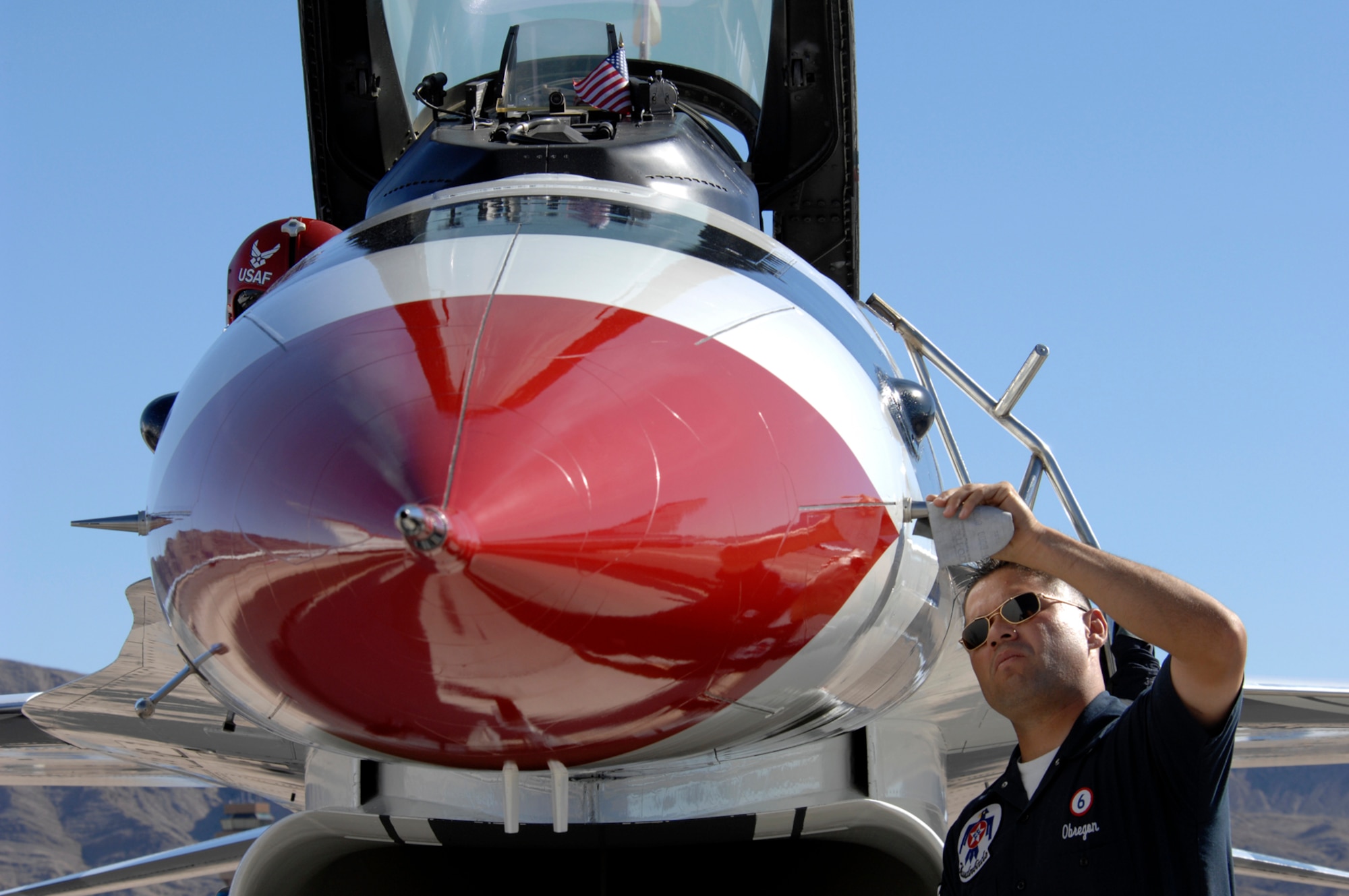 Staff Sgt. Carlos Obregon, U.S. Air Force Air Demonstration Squadron, The Thunderbirds, assistant crew chief for the thunderbird six jet, polishes the crome prior to the Thunderbirds performance during the air show at Nellis Air Force Base, Nev., Nov. 8, 2008. The Nellis AFB air show showcased the 21st-century Air Force’s capabilities in air, space and cyberspace. The show, held Nov. 8-9. is the largest aviation event in Las Vegas and the largest free public event in Nevada.(U.S. Air Force Photo/Senior Airman Larry E. Reid Jr.)