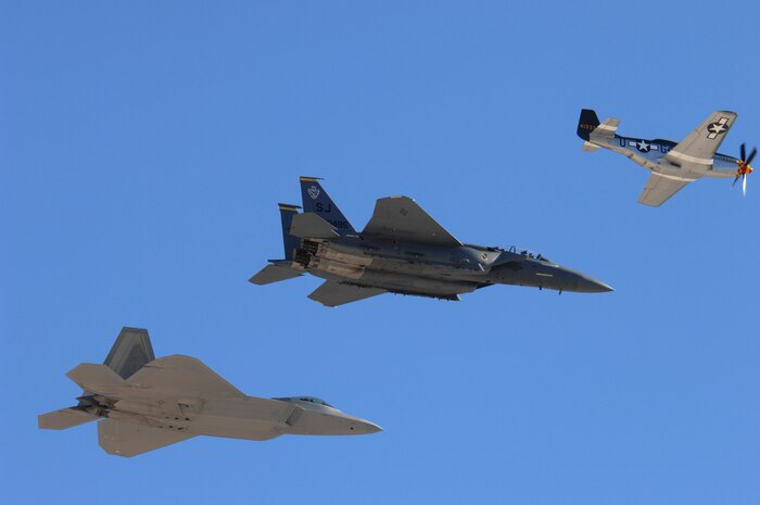 (from left to right) A F-22 Raptor, F-15E Strike Eagle and P-51 Mustang, perform the historic heritage flight during the air show at Nellis Air Force Base, Nev., Nov. 8, 2008. The Nellis AFB air show showcased the 21st-century Air Force’s capabilities in air, space and cyberspace. The show, held Nov. 8-9. is the largest aviation event in Las Vegas and the largest free public event in Nevada.(U.S. Air Force Photo/Senior Airman Larry E. Reid Jr.)