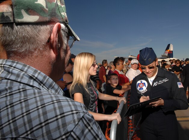 Capt. Amy Glisson, U.S. Air Force Air Demonstration Squadron, The Thunderbirds,  executive officer, signs autographs for fans during the air show at Nellis Air Force Base, Nev., Nov. 8, 2008. The Nellis AFB air show showcased the 21st-century Air Force’s capabilities in air, space and cyberspace. The show, held Nov. 8-9. is the largest aviation event in Las Vegas and the largest free public event in Nevada.(U.S. Air Force Photo/Senior Airman Larry E. Reid Jr.)
