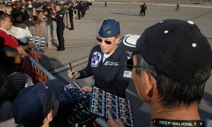 Capt. Amy Glisson, U.S. Air Force Air Demonstration Squadron, The Thunderbirds, executive officer, signs autographs for fans during the air show at Nellis Air Force Base, Nev., Nov. 8, 2008. The Nellis AFB air show showcased the 21st-century Air Force’s capabilities in air, space and cyberspace. The show, held Nov. 8-9. is the largest aviation event in Las Vegas and the largest free public event in Nevada.(U.S. Air Force Photo/Senior Airman Larry E. Reid Jr.)