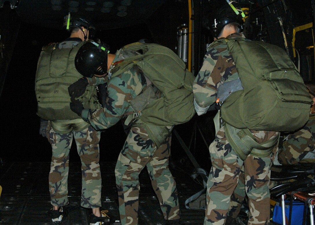 KADENA AIR BASE, Japan -- Members of the 320th Special Tactics Squadron
perform a final equipment check before a high altitude, low opening jump from a 17th Special Operations Squadron MC-130P Combat Shadow here Nov. 5. The 17th lived up to its motto "No mission too demanding" on this flight by also supporting a static-line jump for Marines and Soldiers, aerial refueling HH-60 helicopters and providing a tactical familiarization flight for three Republic of Korea Air Force officers from the 255th Special Operations Squadron and Republic of Korea Air Force Operations Command. (U.S. Air Force photo by Tech. Sgt. Aaron Cram)

