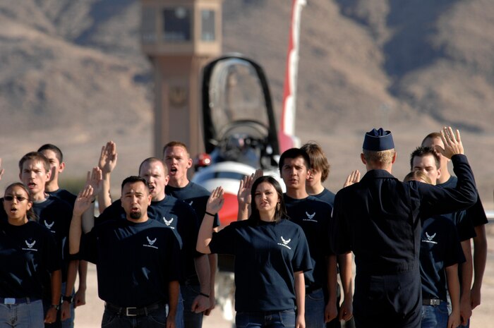 Lt. Col. Greg Thomas (right), commander of the U.S. Air Force Air Demonstration Squadron, The Thunderbirds, administers the oath of enlistment to a group of Air Force delayed entry program recruits during the air show at Nellis Air Force Base, Nev., Nov. 8, 2008. The Nellis AFB air show showcased the 21st-century Air Force’s capabilities in air, space and cyberspace. The show, held Nov. 8-9. is the largest aviation event in Las Vegas and the largest free public event in Nevada.(U.S. Air Force Photo/Senior Airman Larry E. Reid Jr.)