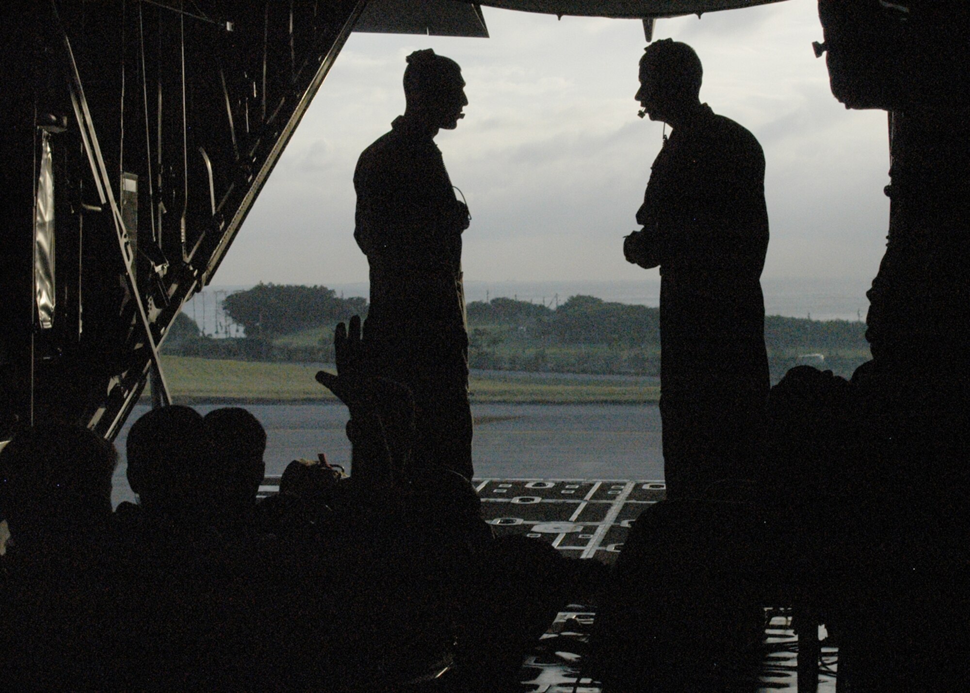KADENA AIR BASE, Japan -- Airman 1st Class Michael Mendes and Staff Sgt. Nicholas Wisnoski, both 17th Special Operations Squadron loadmasters,  discuss final preparations shortly before takeoff aboard a 17th SOS MC-130P Combat Shadow here Nov. 5. The 17th lived up to its motto “No mission too demanding” on this flight by supporting a static-line jump for Marines and Soldiers, supporting a high altitude, low opening jump from 320th Special Tactics Squadron personnel, aerial refueling HH-60 helicopters and a providing a tactical familiarization flight for three Republic of Korea Air Force officers from the 255th Special Operations Squadron and Republic of Korea Air Force Operations Command. (U.S. Air Force photo by Tech. Sgt. Aaron Cram) 