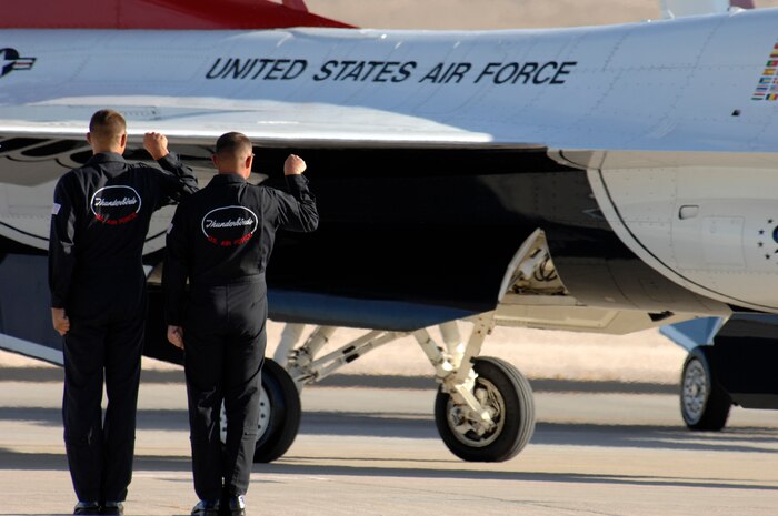 Crew chiefs assigned to the U.S. Air Force Air Demonstration Squadron, The Thunderbirds, signal for their jets departure during the air show at Nellis Air Force Base, Nev., Nov. 8, 2008. The Nellis AFB air show showcased the 21st-century Air Force’s capabilities in air, space and cyberspace. The show, held Nov. 8-9. is the largest aviation event in Las Vegas and the largest free public event in Nevada.(U.S. Air Force Photo/Senior Airman Larry E. Reid Jr.)