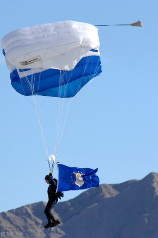 Cadet 1st Class Lindsey Robinson, a parachutist with the Wings of Blue, assigned to the 98th Flying Training Squadron U.S. Air Force Academy, Co., sails from the sky bearing the U.S. Air Force flag during an aerial performance at the Nellis Air Force Base air show, Nev., Nov. 8, 2008. The Nellis AFB air show showcased the 21st-century Air Force’s capabilities in air, space and cyberspace. The show, held Nov. 8-9. is the largest aviation event in Las Vegas and the largest free public event in Nevada.(U.S. Air Force Photo/Senior Airman Larry E. Reid Jr.)