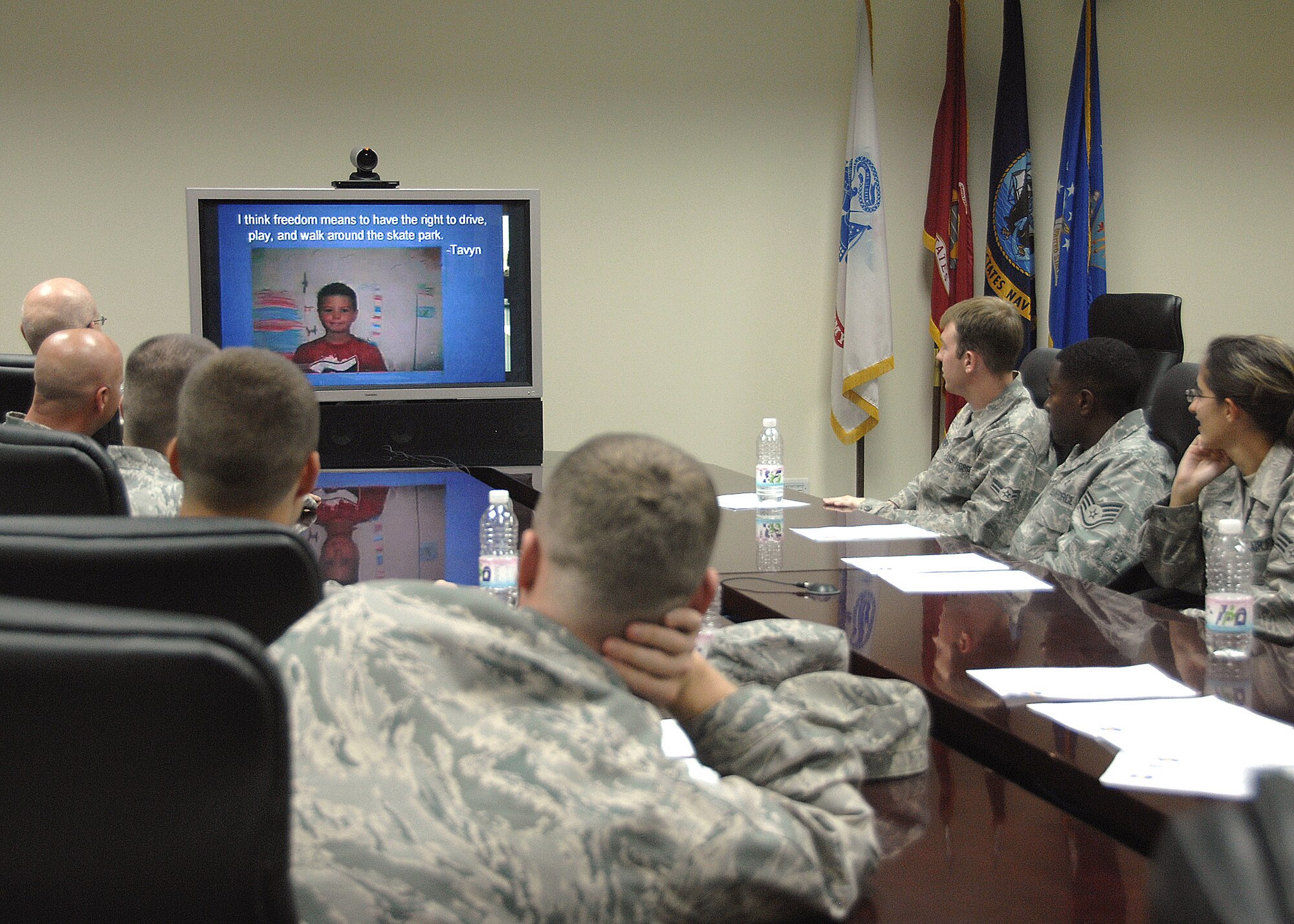 Members of the 386th Expeditionary Logistics Readiness Squadron Aerial Port flight at an air base in Southwest Asia interact with third graders during a video teleconference session Nov. 12 with children from Mustang Valley Elementary school in Mustang, Okla. The children read poems they had written about Veterans Day, and asked questions of the Airmen about their experiences while being deployed in support of operations Iraqi Freedom and Enduring Freedom. The students and teachers at the school are planning to send care packages to the Airmen, thanking them for their service. (U.S. Air Force photo/Tech. Sgt. Raheem Moore)