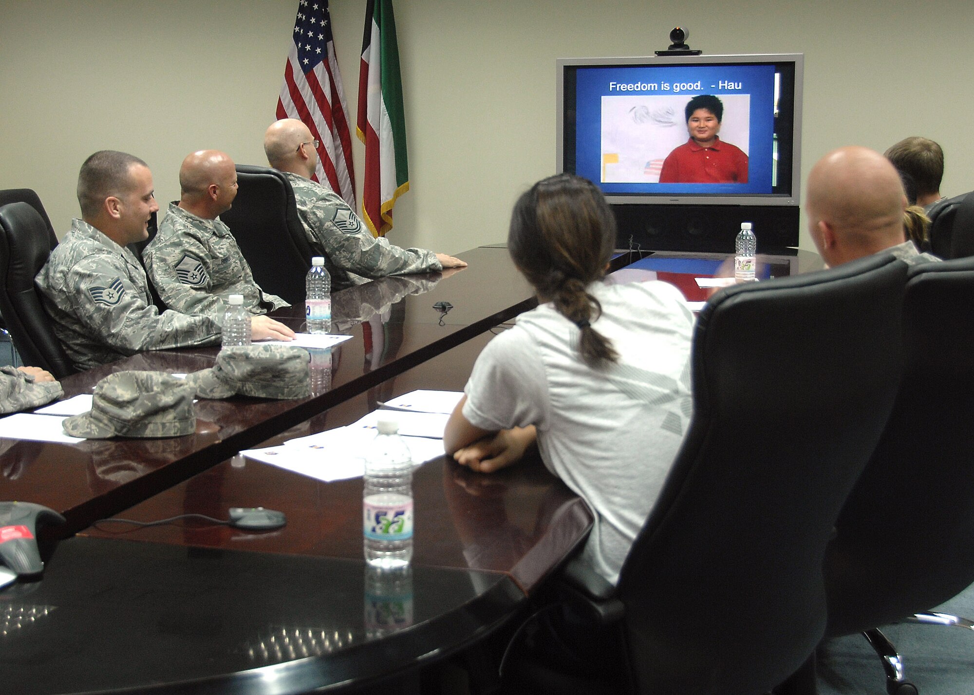 Members of the 386th Expeditionary Logistics Readiness Squadron Aerial Port flight at an air base in Southwest Asia interact with third graders during a video teleconference session Nov. 12 with children from Mustang Valley Elementary school in Mustang, Okla. The children read poems they had written about Veterans Day, and asked questions of the Airmen about their experiences while being deployed in support of operations Iraqi Freedom and Enduring Freedom. The students and teachers at the school are planning to send care packages to the Airmen, thanking them for their service. (U.S. Air Force photo/Tech. Sgt. Raheem Moore)