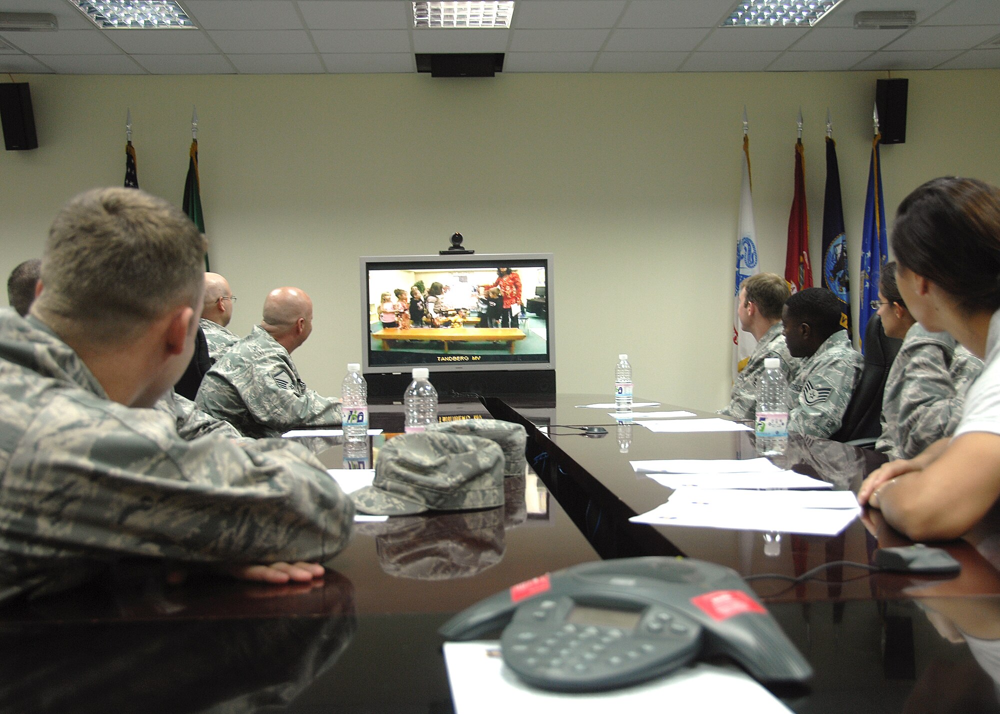 Members of the 386th Expeditionary Logistics Readiness Squadron Aerial Port flight at an air base in Southwest Asia interact with third graders during a video teleconference session Nov. 12 with children from Mustang Valley Elementary school in Mustang, Okla. The children read poems they had written about Veterans Day, and asked questions of the Airmen about their experiences while being deployed in support of operations Iraqi Freedom and Enduring Freedom. The students and teachers at the school are planning to send care packages to the Airmen, thanking them for their service. (U.S. Air Force photo/Tech. Sgt. Raheem Moore)