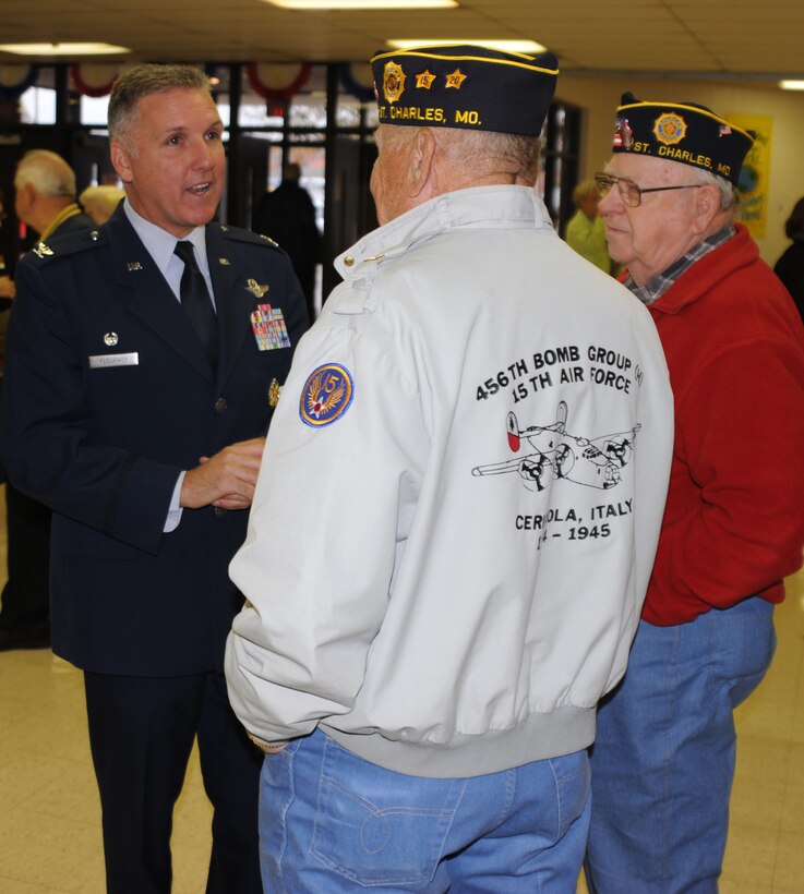 Fellow veterans and members of the St. Charles community talk with Col. John C. Flournoy, Jr., (left) after his Veteran's Day presentation to students, faculty and the public at Fort Zumwalt's school district in Missouri. The Colonel is the commander of the 932nd Airlift Wing, Air Force Reserve, located at Scott Air Force Base near Belleville, Ill.  The 932nd Airlift Wing flies both the C-9C and C-40C distinguished visitor aircraft. These American Legion members (right) are World War II veterans who came out to the event presented by thee South Middle School Veterans Appreciation Committee. In addition to guest speaker Col. Flournoy, the 8th grade band, orchestra and concert choir all performed.   (U.S. Air Force photo/Tech. Sgt. Gerald Sonnenberg)