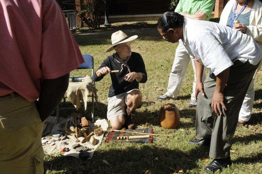 Scott Jones, center, displays primitive skills such as tool making and making fire. U. S. Air Force photo by Sue Sapp