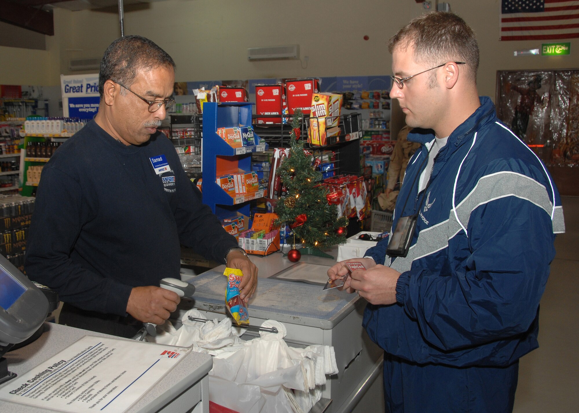 SOUTHWEST ASIA -- Staff Sgt. David Myers, 586th Expeditionary Security Forces Squadron, pays for his purchases at the Base Exchange with an Eagle Cash card on Nov. 10 at an air base in Southwest Asia. Eagle Cash is a management tool designed to support U.S. military personnel deployed in combat zones and peacekeeping missions. The 386th Air Expeditionary Wing Finance office has issued more than 3,500 Eagle Cash cards since January 2008. The card can be used to pay for goods and services at military installations throughout the U.S. Central Command area of responsibility. Sergeant Myers is deployed from Holloman Air Force Base, N.M. (U.S. Air Force photo/Tech. Sgt. Raheem Moore)