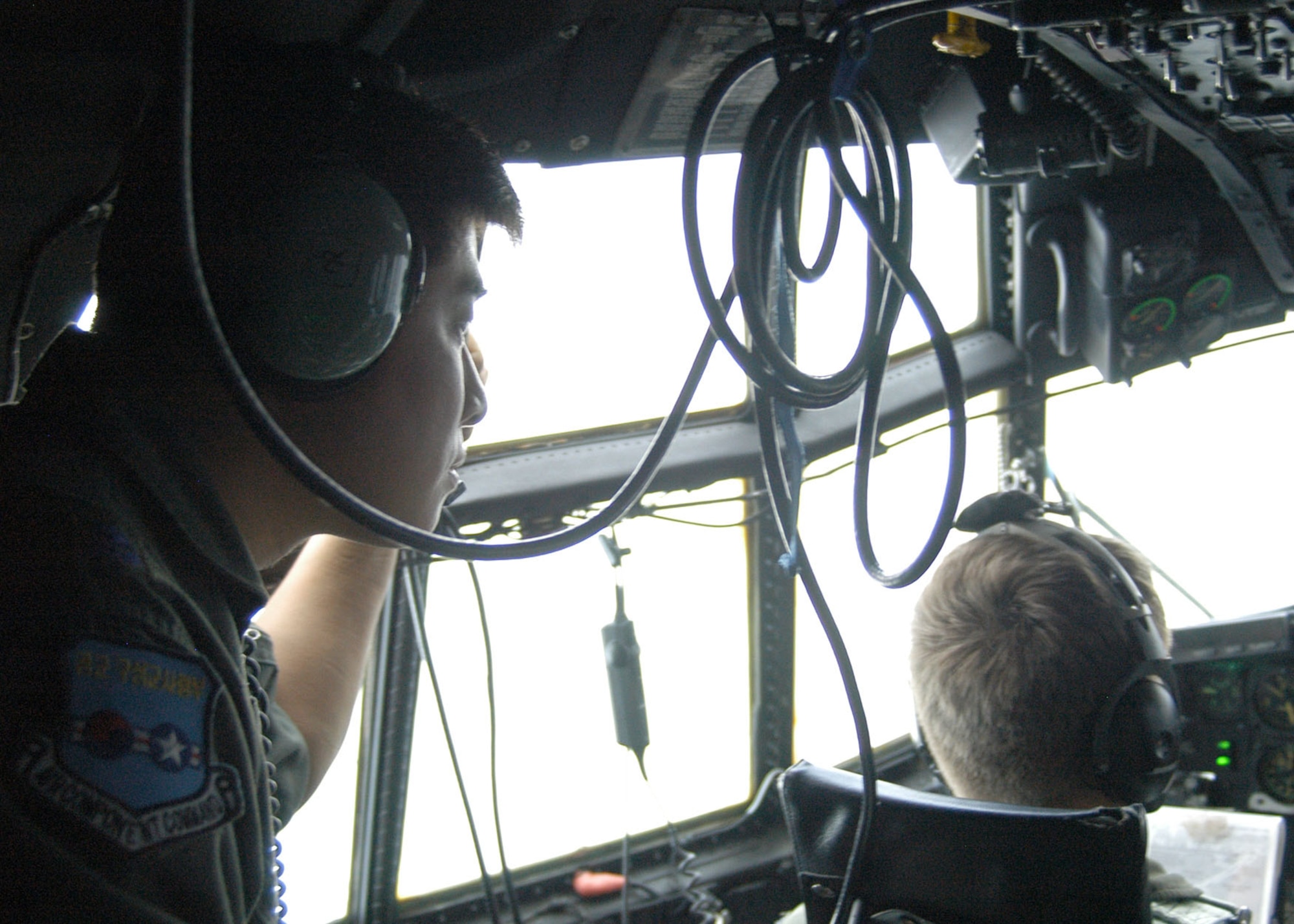 KADENA AIR BASE, Japan -- Republic of Korea Air Force Maj. Eui Sik Kim, a Republic of Korea Air Force Operations Command special operations planner, looks out the cockpit windows during a flight  aboard a 17th Special Operations Squadron MC-130P Combat Shadow here Nov. 5. Col. David Mullins, the 353rd Special Operations Group commander, invited the ROKAF special operators from the 255th Special Operations Squadron and ROKAF Operations Command to visit Nov. 3 -6 to see how the group trains, equips and coordinates its MC-130 aircrews.  The 353rd SOG and 255th SOS are both part of the Combined Joint Special Operations Air Component which supports special operations missions in the Pacific. (U.S. Air Force photo by Tech. Sgt. Aaron Cram)                                 