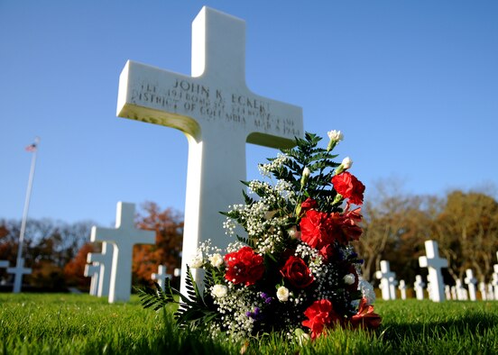 During the Veterans Day Ceremony, a bouquet of flowers rests on the grave of 1st Lt. John K. Eckert who lies resting at the Cambridge American Cemetery Nov. 12, 2008, Cambridge, England. The Veterans Day ceremony was held here to honor all servicemen and women who served in the United States military, and especially for those who paid the ultimate price while fighting for our freedom. (U.S. Air Force photo by Staff Sgt. Jerry Fleshman)