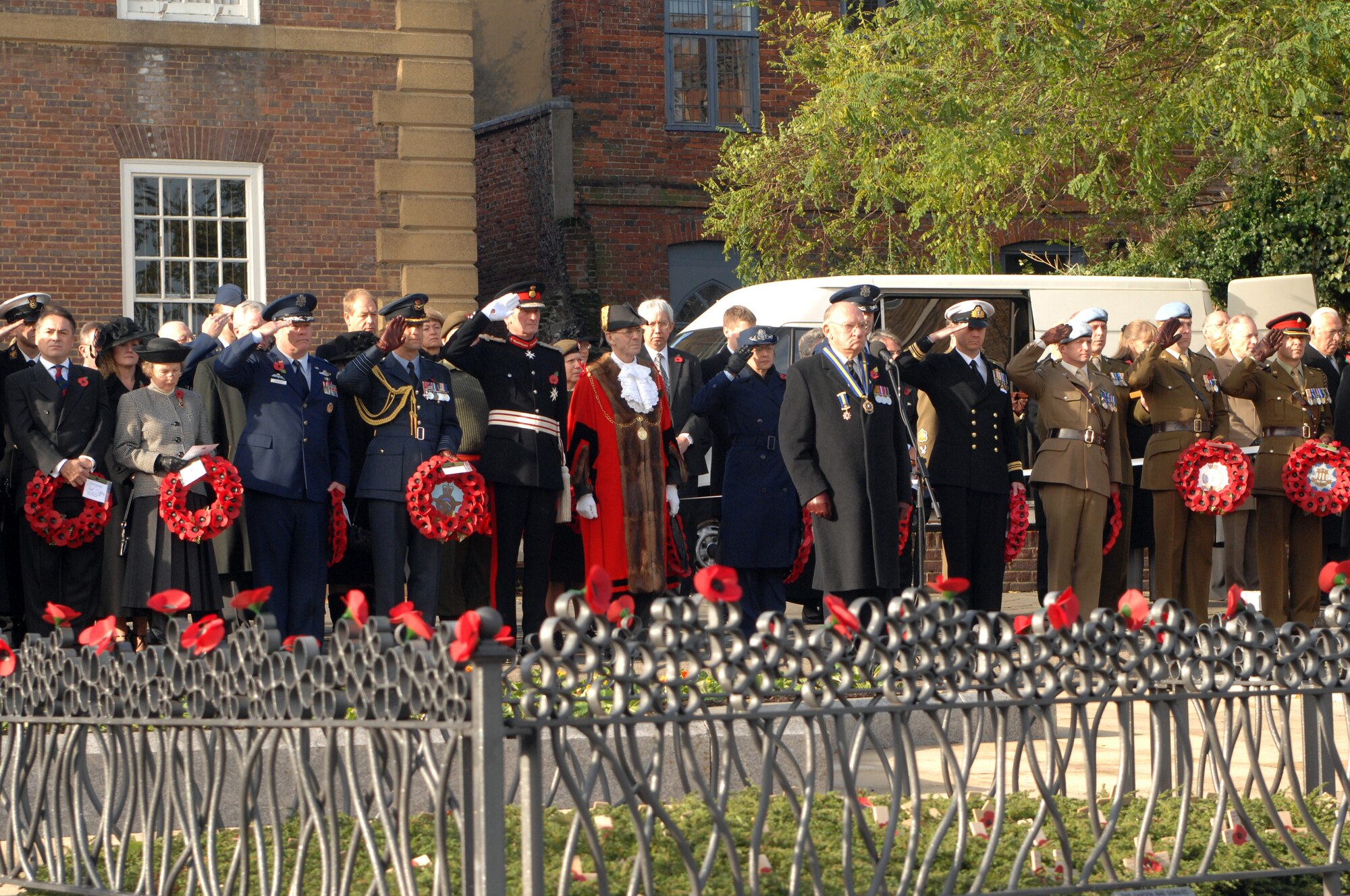 Military and civic dignitaries salute during two minutes of silence during the Remembrance Day ceremony at Angel Hill, Bury St. Edmunds Nov.9, 2008. Remembrance Day originally started to honor those who lost their lives or were injured during World War I with the tradition of wearing red poppies on civilian clothing and laying poppy wreaths at memorial sites. (U.S. Air Force photo by Senior Airman Teresa M. Hawkins)