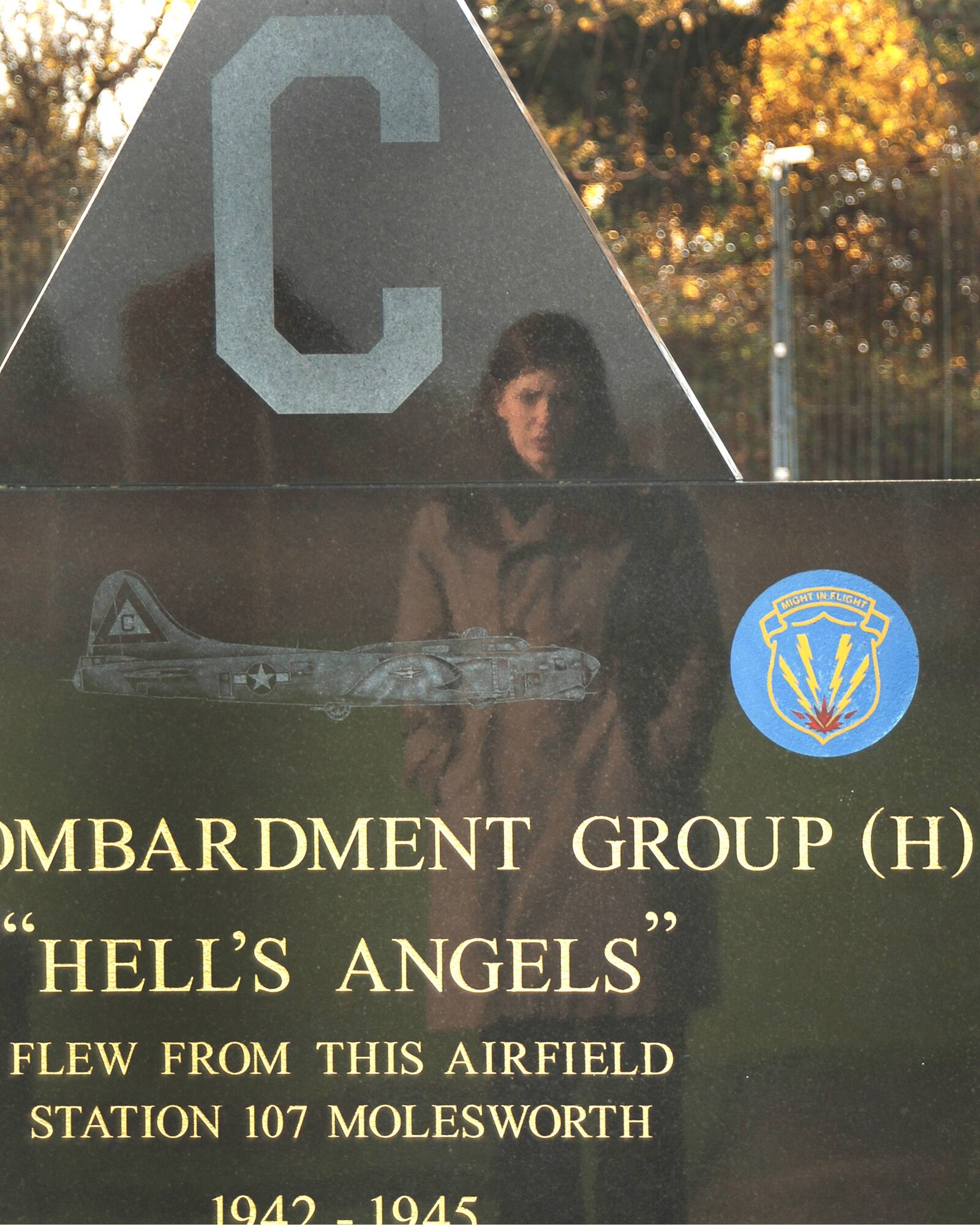 Ms. Kelly Akens is reflected in the marble as she contemplates the inscription on the 303rd Bomb Group (Heavy) Memorial at RAF Molesworth, England during her November 7th visit to the base. Ms. Akens, who is the grandaughter of Sergeant Thomas I. Akens who served at Molesworth in 1945 during the Second World War, is the first 303rd Bomb Group grandchild to visit Molesworth. (U.S. Air Force Photo by Ms. Stacey Logan)