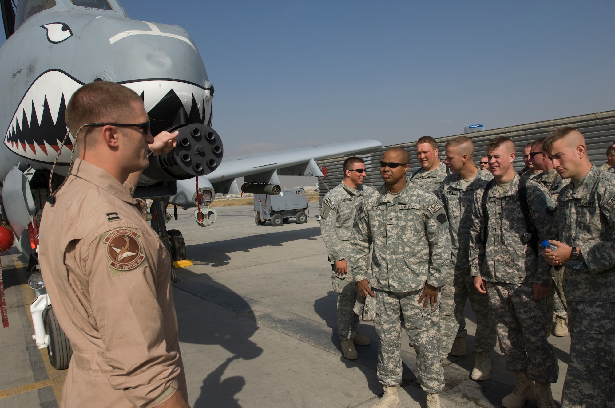 BAGRAM AIR FIELD, Afghanistan -- Capt. Dylan Thorpe, an A-10 Thunderbolt II pilot, talks about the 30MM cannon on the A-10 with Pennsylvania Army National Guard Soldiers during a recent visit to Bagram's fighter squadrons. Members from the F-15E 391st Expeditionary Fighter Squadron and A-10 75th Expeditionary Fighter Squadron hosted the visit after the Soldiers had expressed a desire to personally thank pilots who fly close-air support missions to support troops on the ground engaged in fire-fights with enemy forces. The A-10's 30mm weapon is a vital asset to Solders on front lines who need close-air support. (U.S. Air Force photo/Master Sgt. Keith Brown)