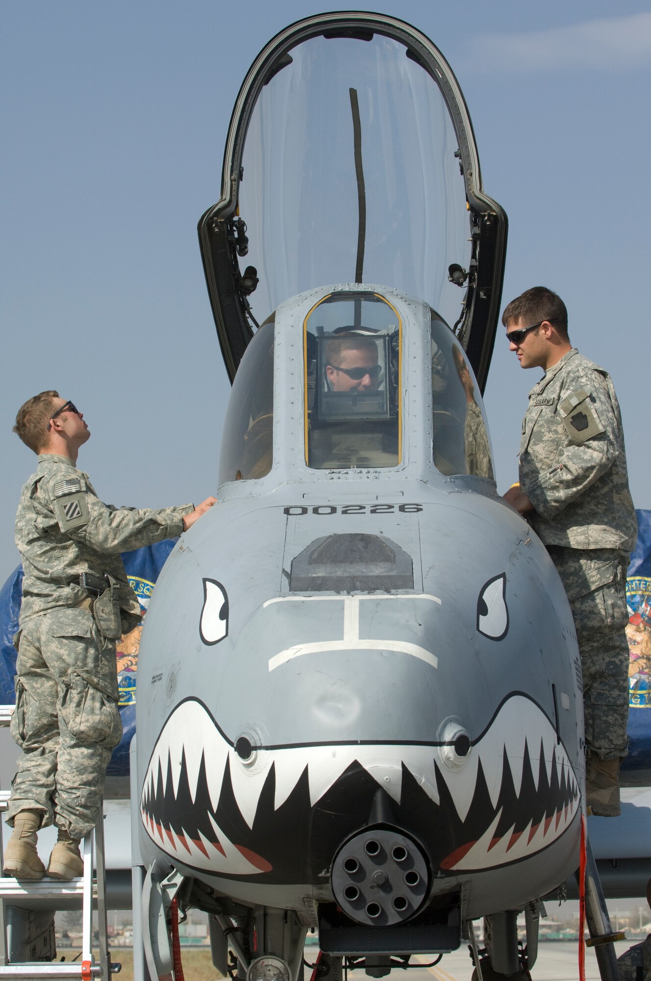 BAGRAM AIR FIELD, Afghanistan -- Pennsylvania Army National Guard Soldiers Sgt. Mervin Hengst (left) and Staff Sgt. Donald Zerbe (right) learn about the A-10 Thunderbolt II from Capt. Robert Burdette during a recent visit to Bagram Air Field's fighter squadrons. Members from the F-15E 391st Expeditionary Fighter Squadron and A-10 75th Expeditionary Fighter Squadron hosted the visit after the Soldiers had expressed a desire to personally thank pilots who provide close-air support for troops on the ground while engaged in fire fights with enemy forces. (U.S. Air Force photo/Master Sgt. Keith Brown)