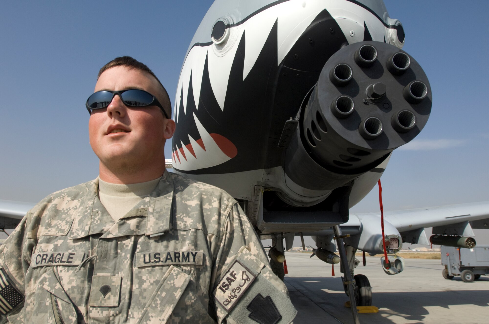 BAGRAM AIR FIELD, Afghanistan -- Pennsylvania National Guard Spc. Jeffery Cragle stands next to the 30mm cannon on a A-10 Thunderbolt II during visit by the National Guard Soldiers to the 391st and 75th Expeditionary Fighter Squadron's. Members from the squadrons hosted the Soldiers after they expressed a desire to thank pilots who provide close-air support for ground troops engaged in firefights with the enemy forces. (U.S. Air Force photo by Master Sgt. Keith Brown)