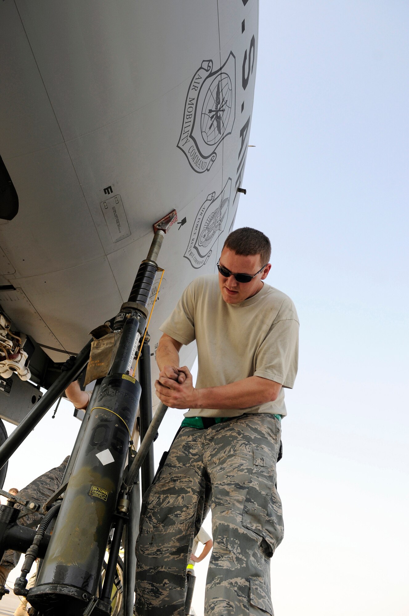 Senior Airman Robert Lewis, aircraft maintenance journeyman assigned to the 379th Expeditionary Aircraft Maintenance Squadron, raises a jack at the front of a KC-135 Stratotanker, Nov. 12, at an undisclosed air base in Southwest Asia.  The front jack holds the front of the aircraft level as it is being jacked up for a landing gear strut replacement.  Stratotankers provide the core aerial refueling capability for the Air Force, Navy, Marine Corps and allied nation aircraft operating in the Central Command area of responsibility.  Airman Lewis hails from Kilbourne, La., and is deployed from McConnell Air Force Base, Kan., in support of Operations Iraqi and Enduring Freedom and Joint Task Force-Horn of Africa.  (U.S. Air Force photo by Tech. Sgt. Michael Boquette/Released)