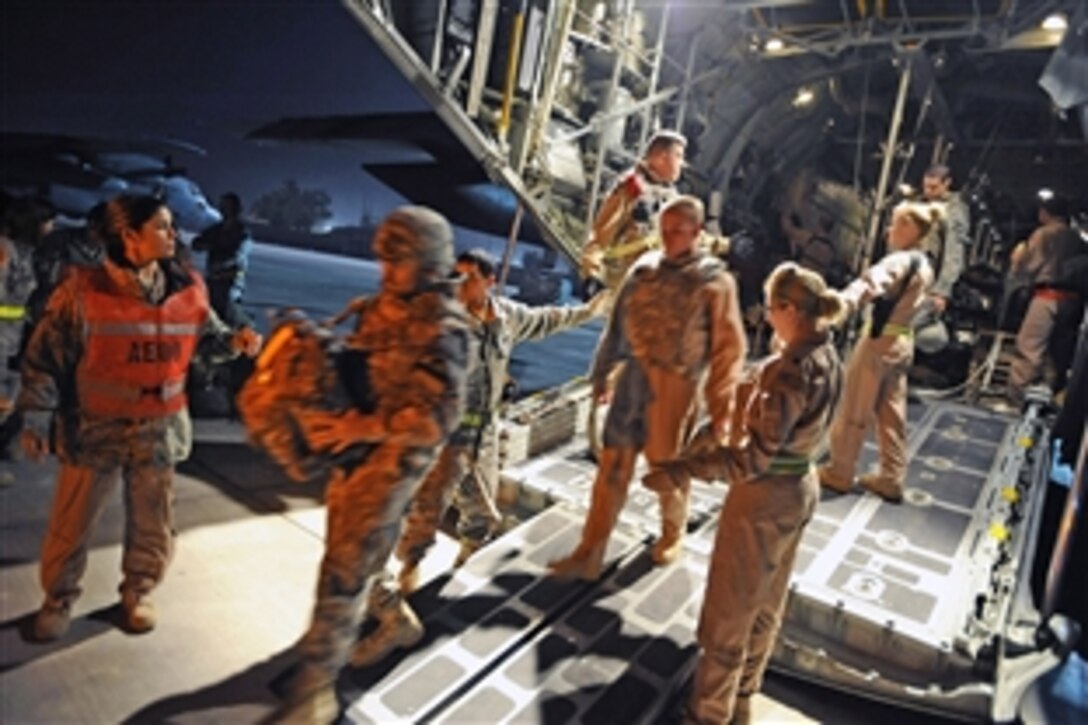 Ambulatory patients depart a C-130 Hercules assigned to the 777th Expeditionary Airlift Squadron at Joint Base Balad, Iraq, Nov. 8, 2008. Two Iraqi doctors from Iraq's Ministry of Defense accompanied an aeromedical evacuation mission to study U.S. Air Force aeromedical evacuation procedures so that they can establish an aeromedical evacuation service for the Iraqi air force.