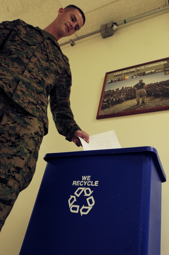 Lance Cpl. Scott A. James, U.S. Marine Corps Forces, Pacific G-6 customer service liaison representative, does his part to reduce waste by recycling paper. MarForPac personnel can now take recyclable paper products to a white dumpster located behind building one, near the post office, labeled 'Honolulu Recovery System.'