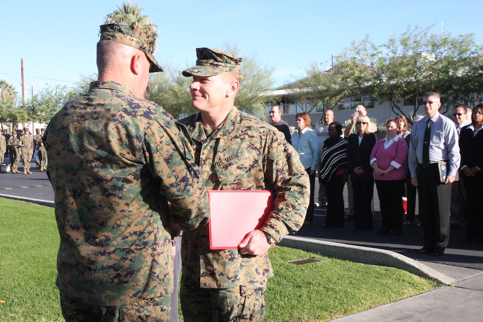 Lt. Col. David Bernatovich, the assistant chief of staff of G-8, shakes the hand of Brig. Gen. Charles M. Gurganus, the commanding general of the Marine Corps Air Ground Combat Center, after receiving a certificate of commendation on behalf of the comptroller’s directorate during a ceremony Nov. 12 recognizing the directorate’s exceptional work over the past year. According to the certificate of commendation the G-8 staff performed in a superb manner demonstrating unparallel success in providing budgeting and accounting support, funds management, and financial oversight which fully supported the complex MAGTFTC and MCAGCC mission. Bernatovich, a native of Nanticoke, Pa., attributed the directorate’s success to the estimated 35 civilian personnel who worked hard to appropriate funds for the Combat Center’s many financial needs and to make sure those funds were spent efficiently. ::r::::n::::r::::n::