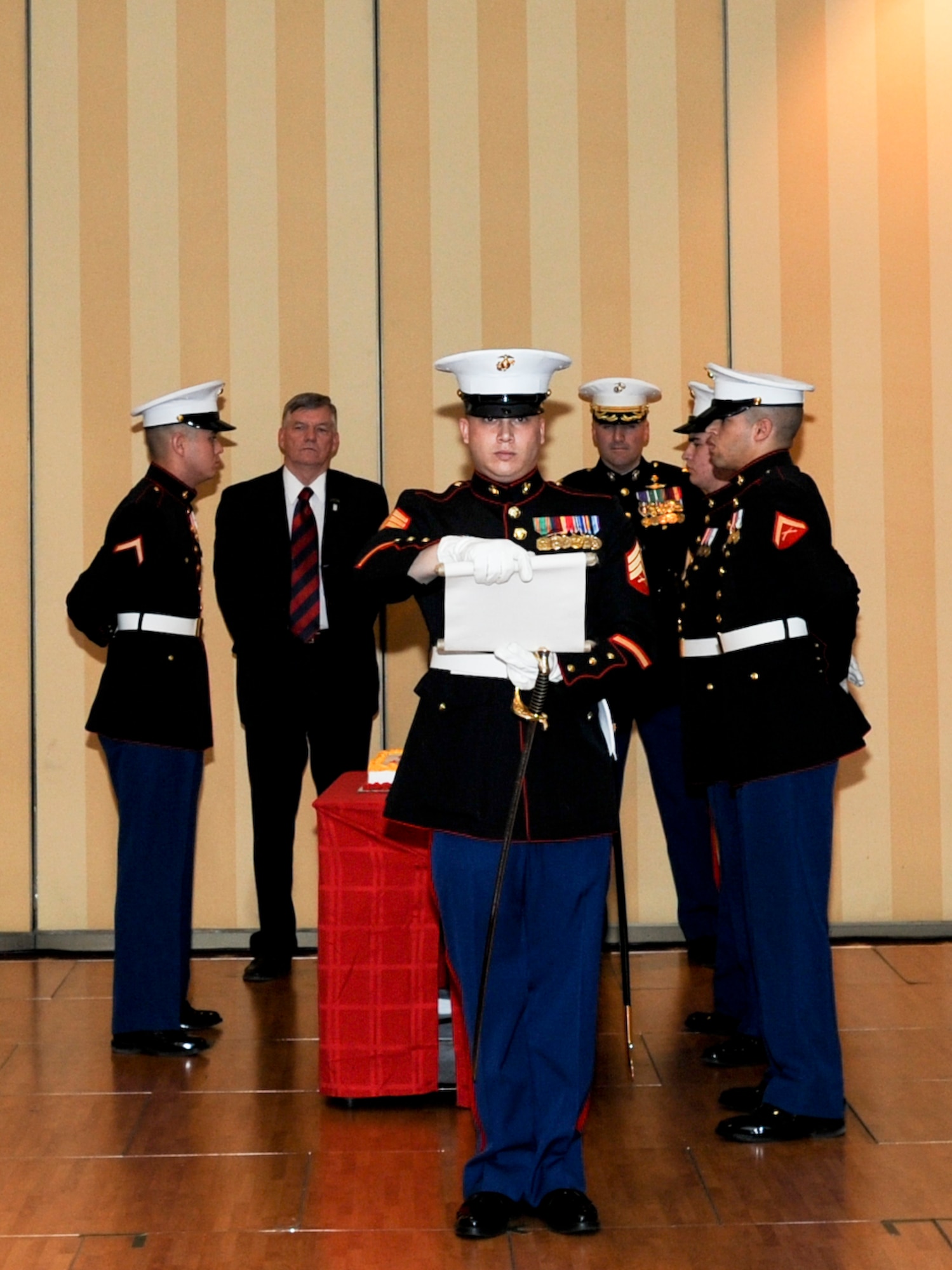 ANCHORAGE, Alaska -- Marine Corps Sgt. Hollis Versyp, Company D (-) Anti Terrorism Battalion, reads the General Lejeune's birthday message prior to the cake cutting ceremony at the 233rd U.S. Marine Corps Birthday Ball. The cake cutting ceremony is a tradition that demonstrates the passage of time and knowledge between old and new Marines. (U.S. Air Force photo/Staff Sgt. Joshua Garcia)