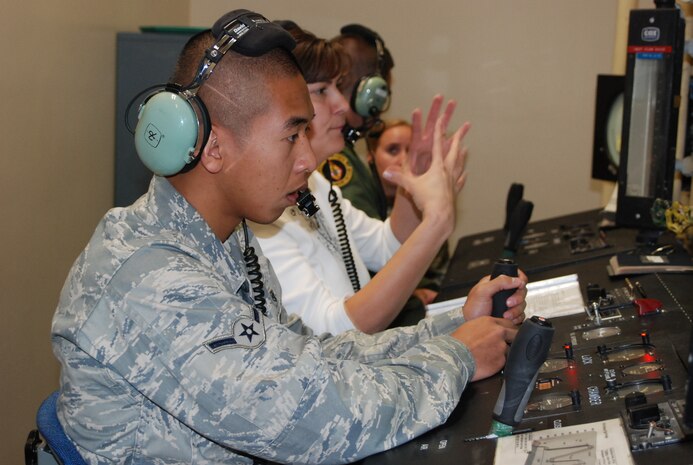 Claire Rowan, an Aerospace Physiological Training Flight assistant technician director,and Airman Jimmy Sayarath, an APTF Aerospace Physiological Technician monitor a high-altitude chamber flight Nov. 13, at the 9th Physiological Support Squadron. Sayarath was in charge of regulating the altitude of the chamber, while Rowan informed crew members on what scenarios were taking place. (Photo by Airman 1st Class Chuck Broadway)